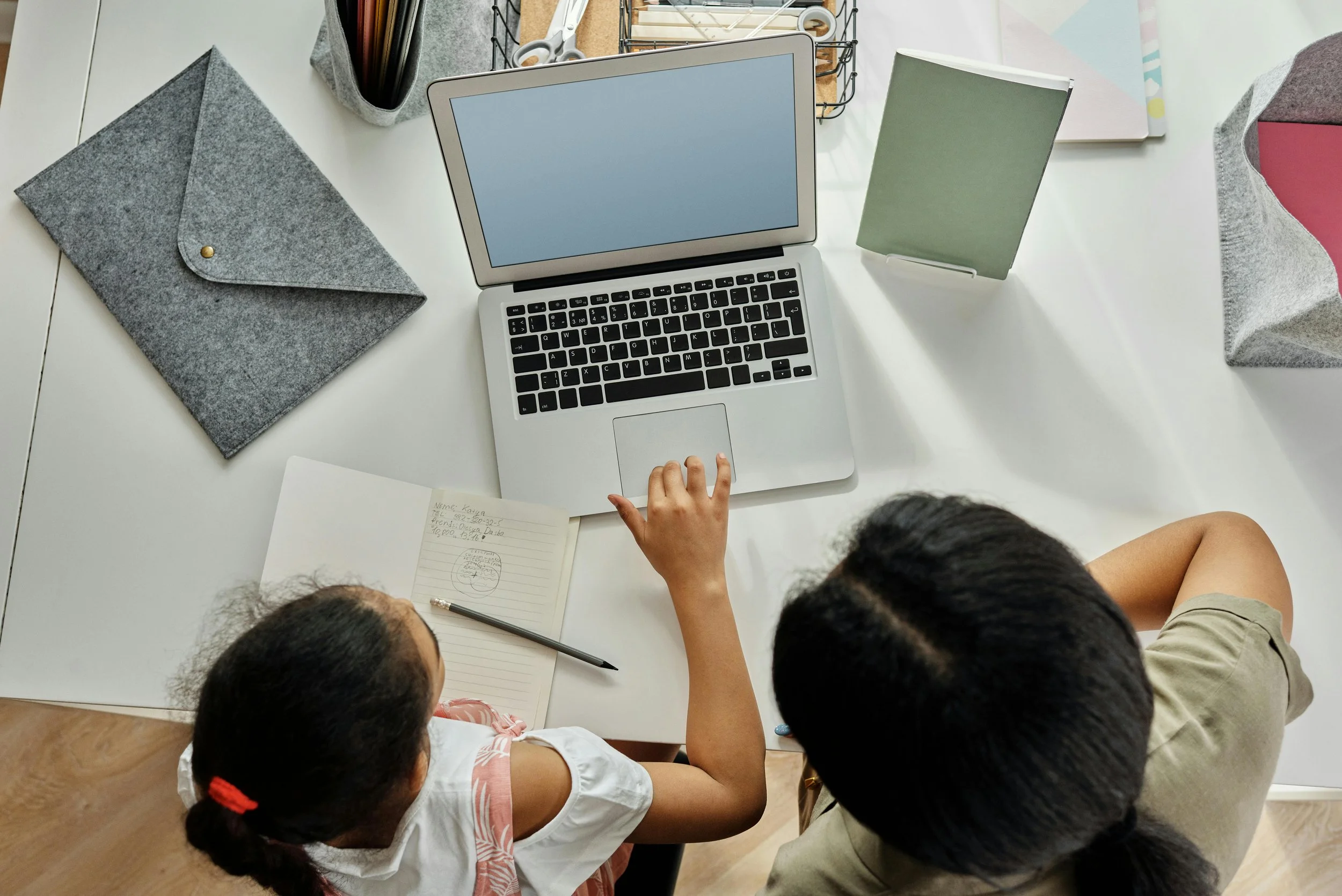A student and their parent working on a laptop