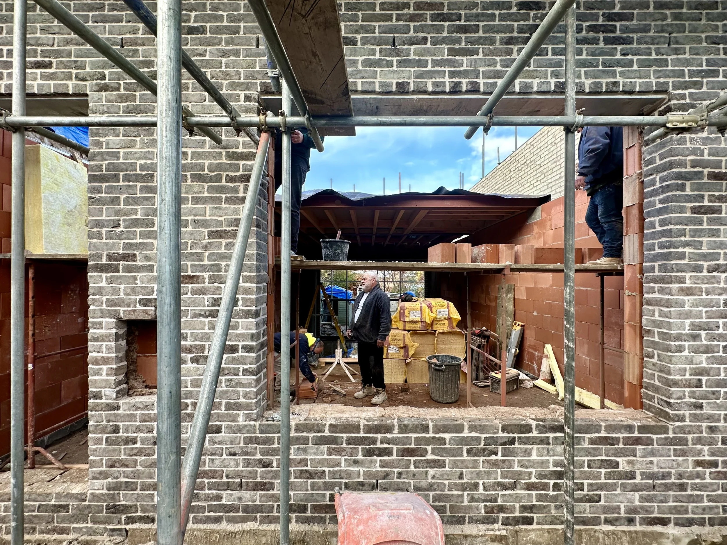 work in progress view of castlands road showing brick and clay block construction