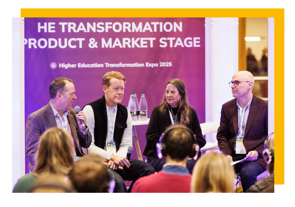 A group of speakers talking to an audience in front of the HE Transformation Product & Market Stage