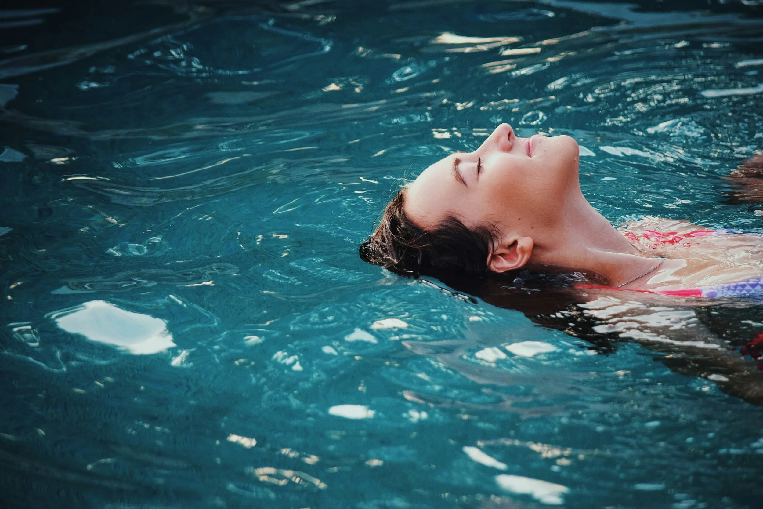 Woman dipping hair in water