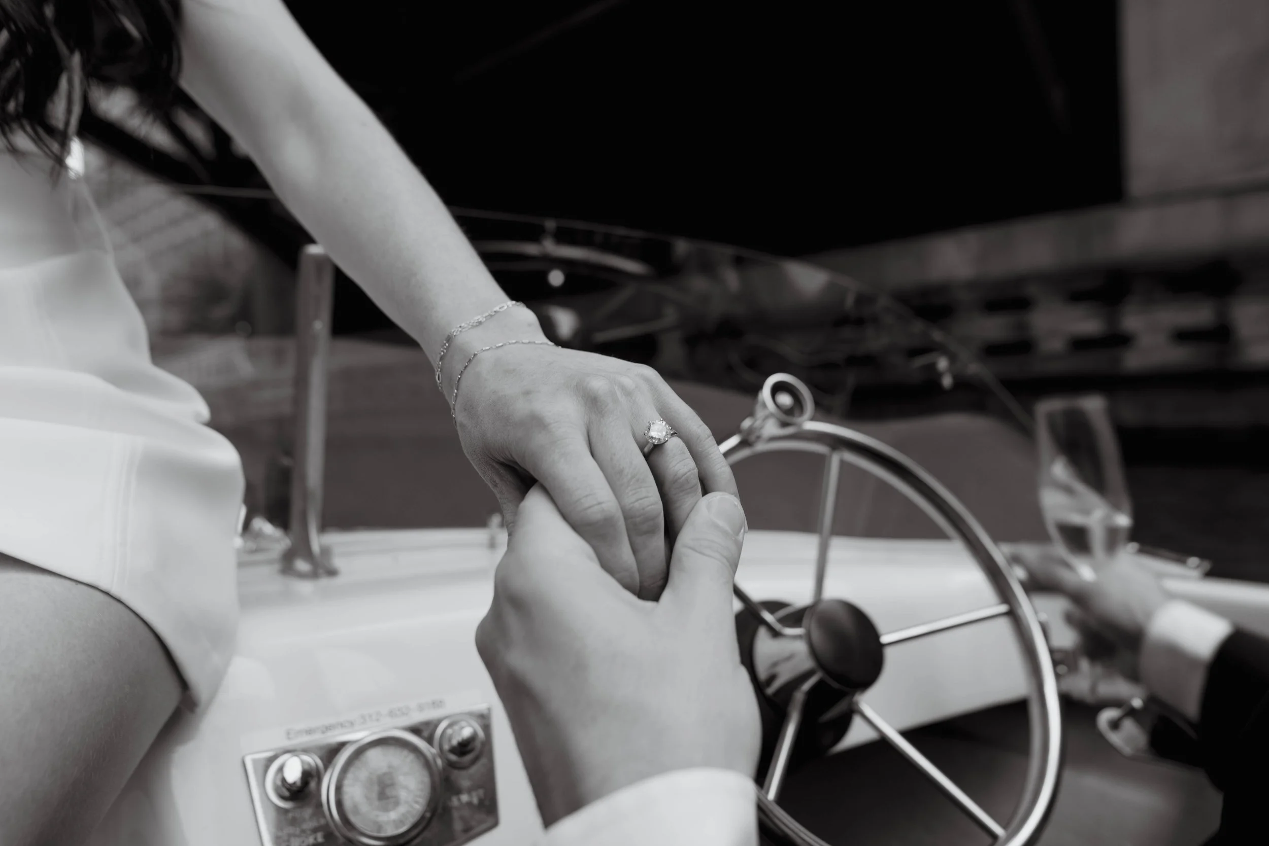Jarae Comstock shoots engagement ring on Chicago Boat in vintage boat engagement photoshoot