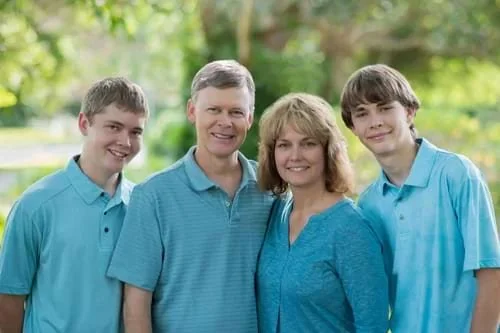 Close-up of Diane Dultmeier’s family of four smiling outdoors in Stuart, Florida