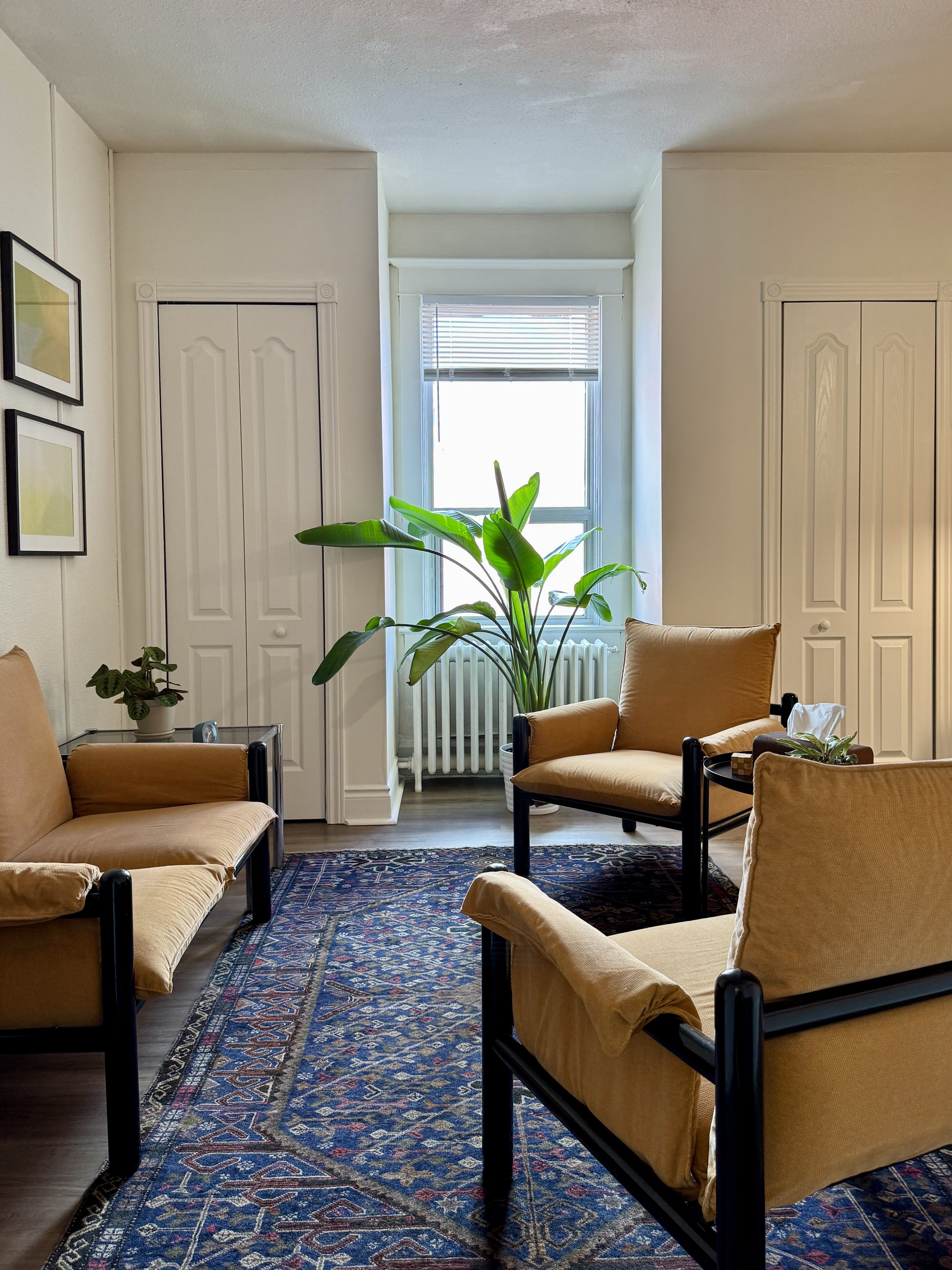 “Therapy office room with three chairs arranged for counseling session”