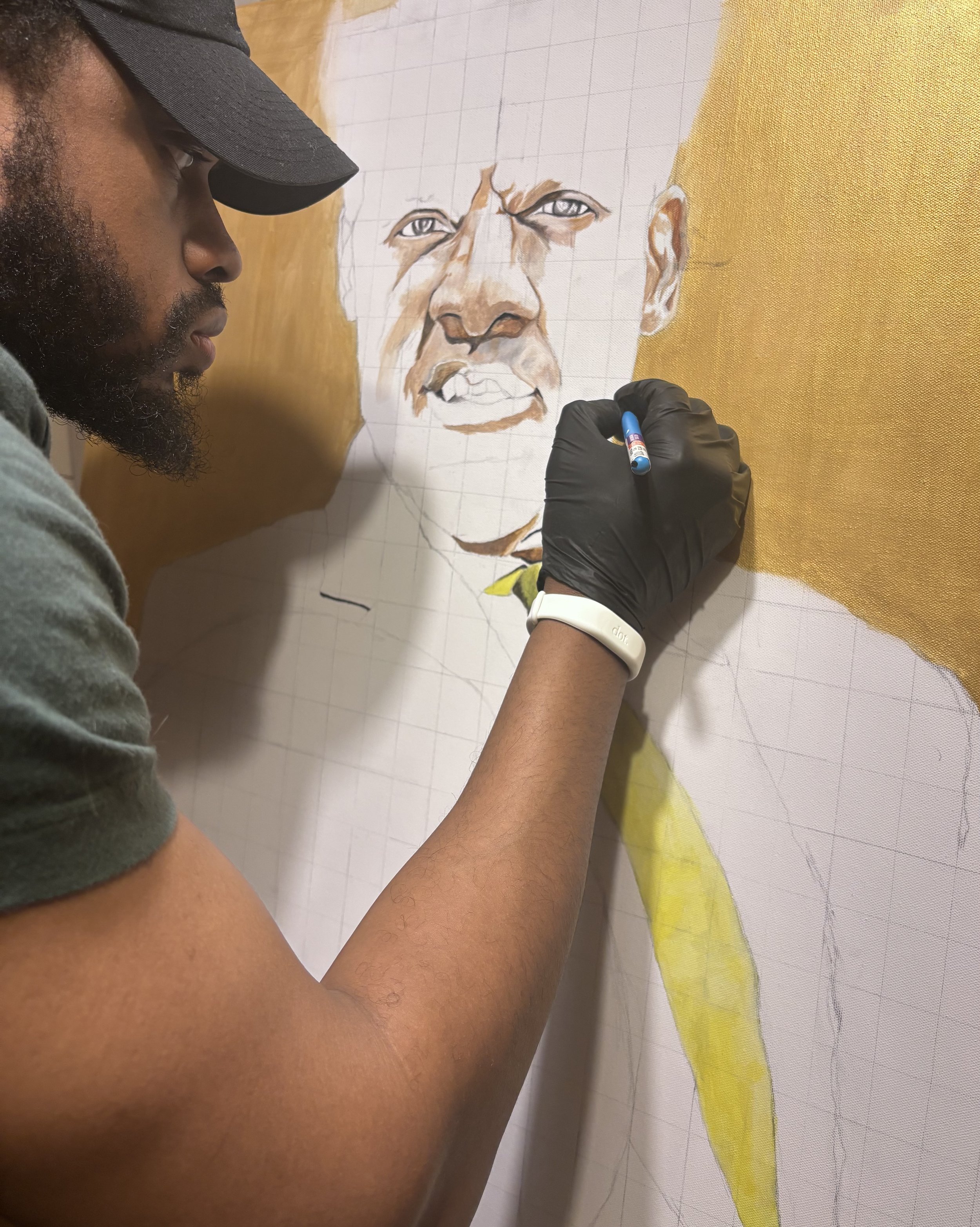 An artist is painting a portrait of a woman on a large canvas, using a pencil and watercolor paints, with the woman’s face partly finished and detailed.