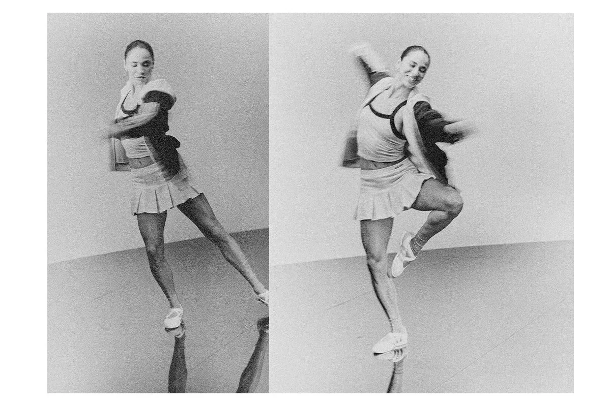 Black and white photo of a woman dancing or jumping, split into two parts showing different poses, in a room with plain walls and floor.