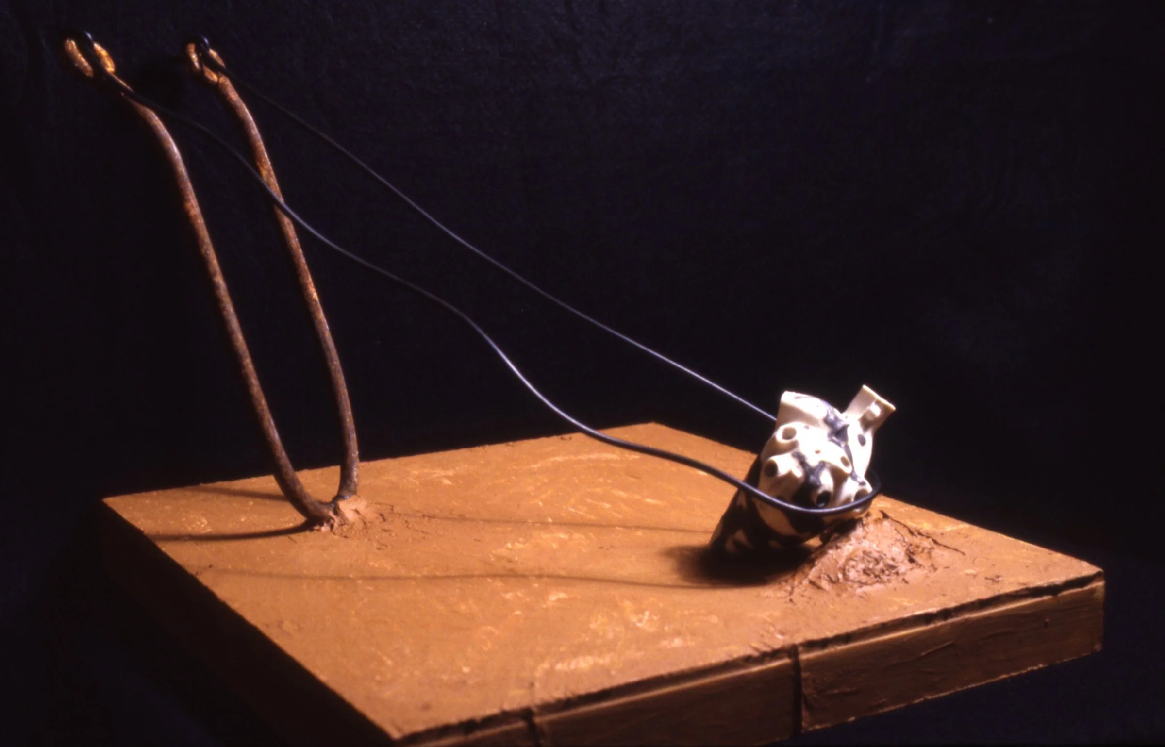 'Catapault', porcelain heart, steel, leather, 12" x 12" x 12"