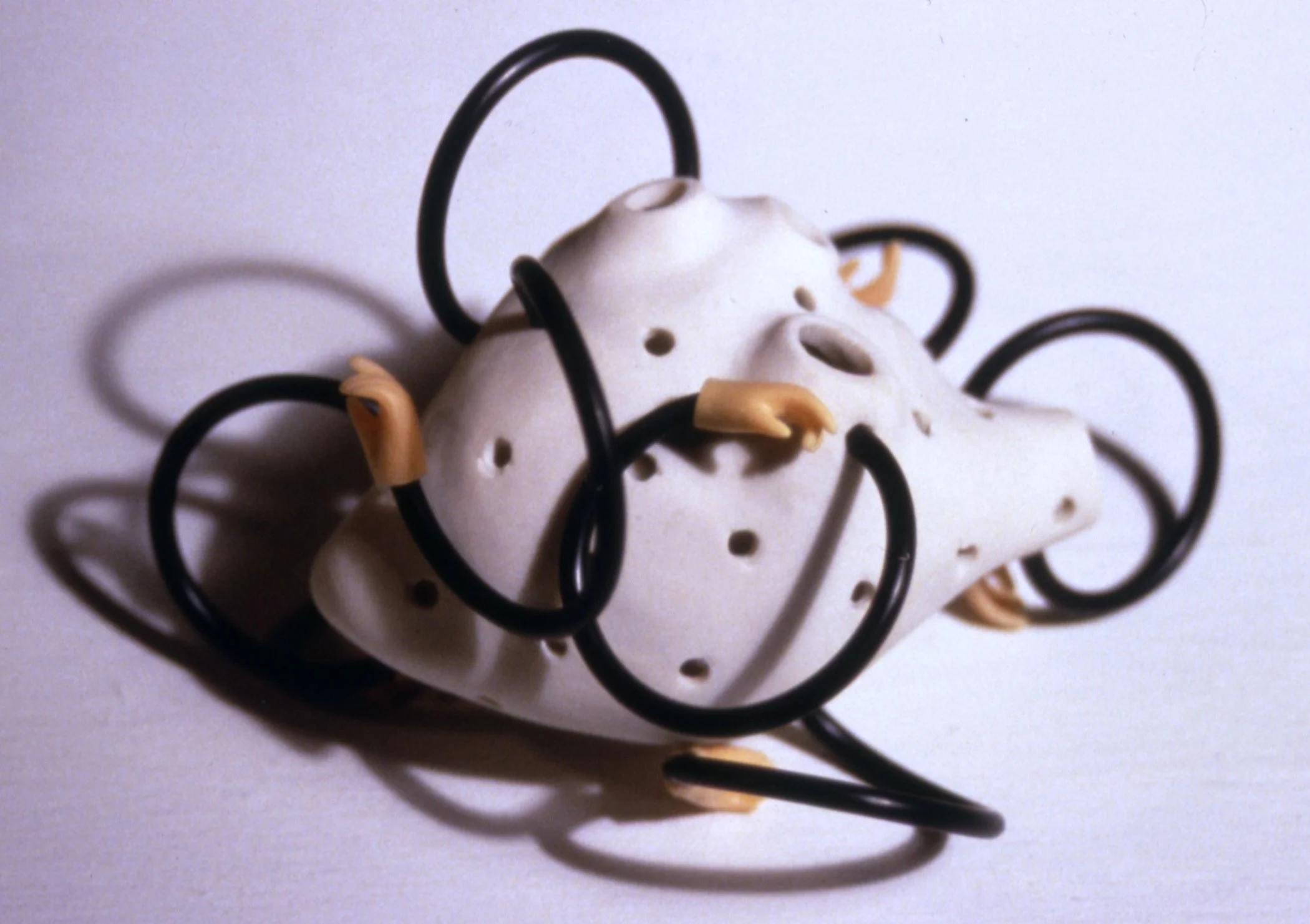 'Itch', porcelain heart, rubber, plastic hands, 6" x 6" x 6"