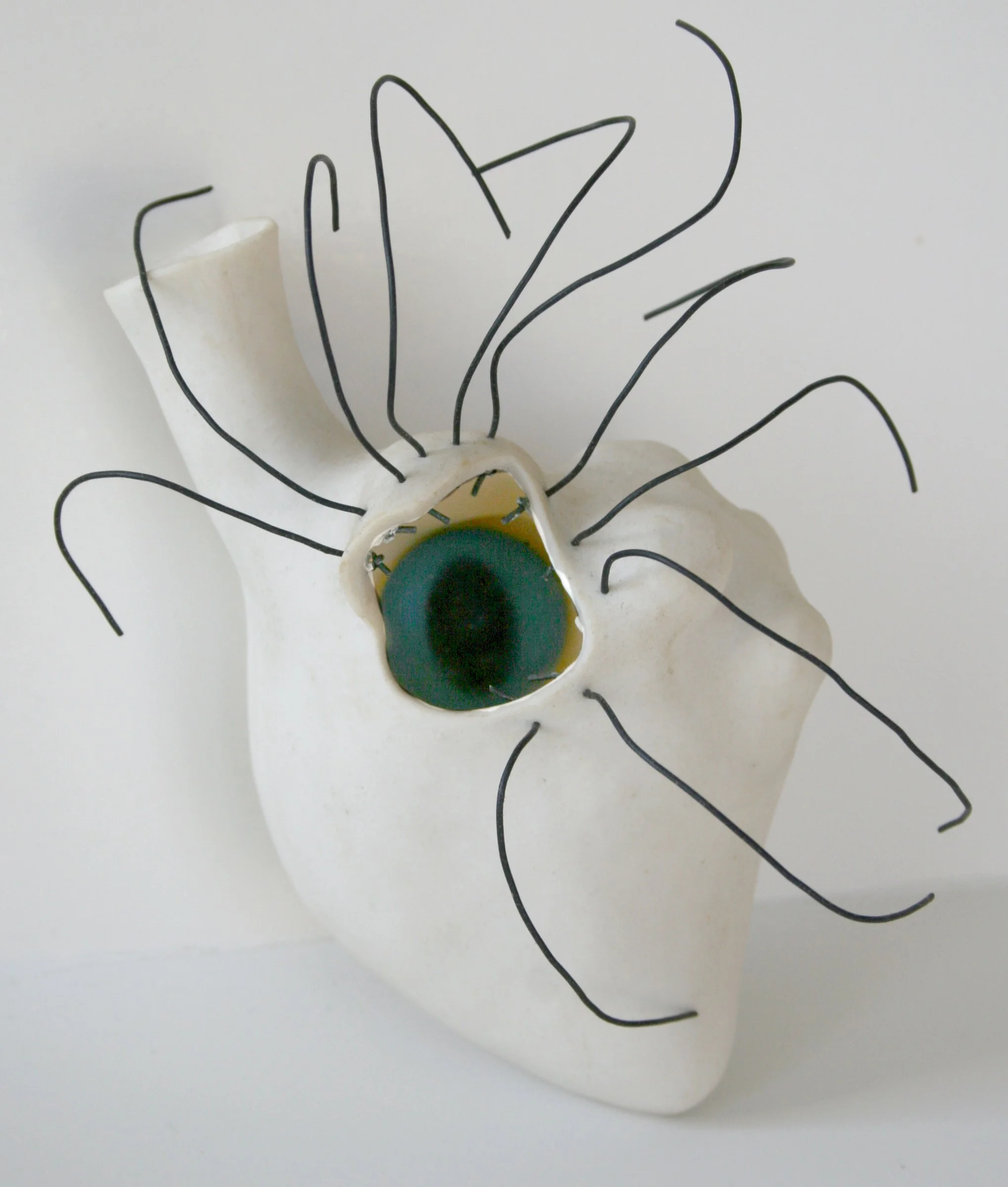 'Cyclops, porcelain heart, wire, glass eye, 4" x 6" x 4"