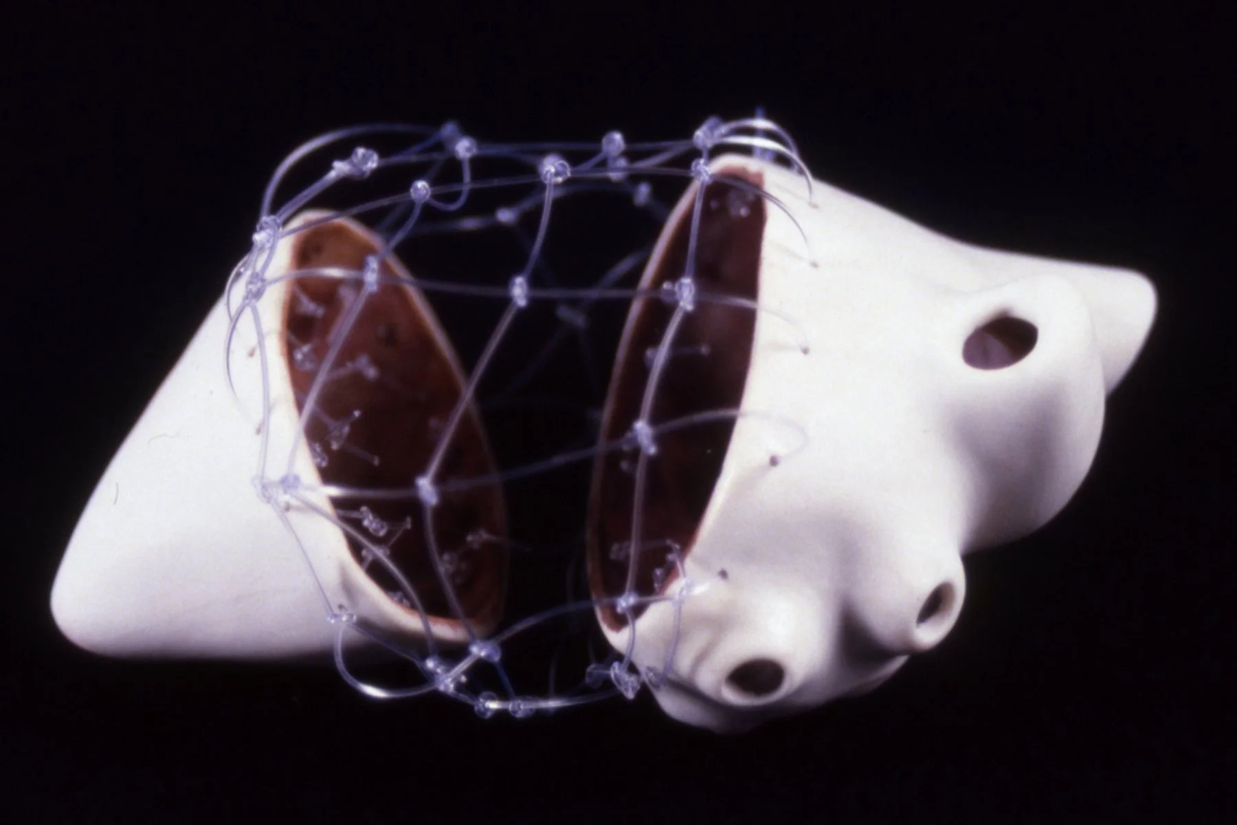 'East Meets West', split porcelain heart,  filament, 4" x 6" x 4"