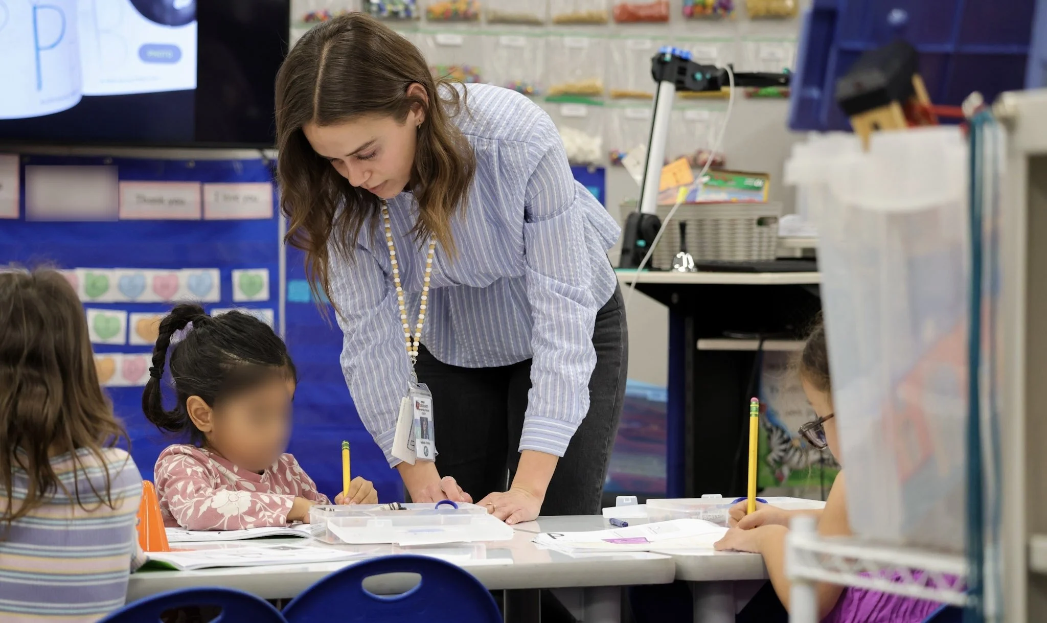 Working individually with a student to support her with her work. 