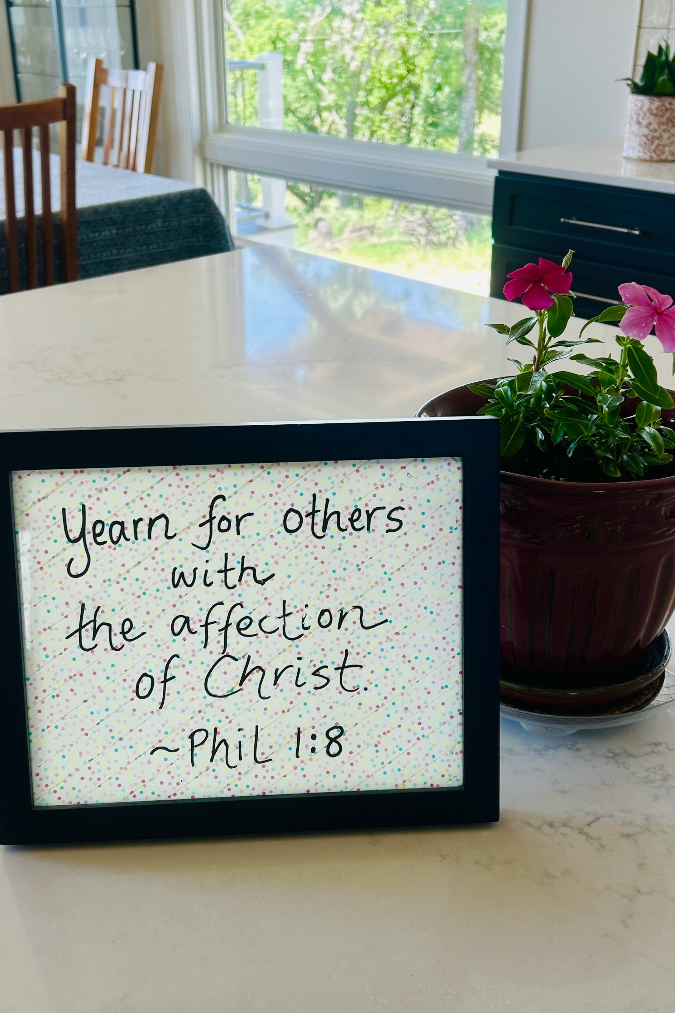 Handwritten Scripture reminder displayed on a farmhouse kitchen counter.