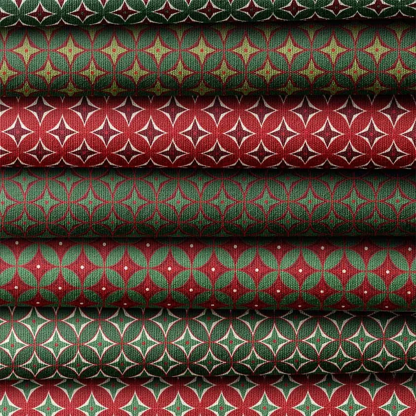 Stack of red and green Christmas fabrics with coordinating geometric star and circle patterns.