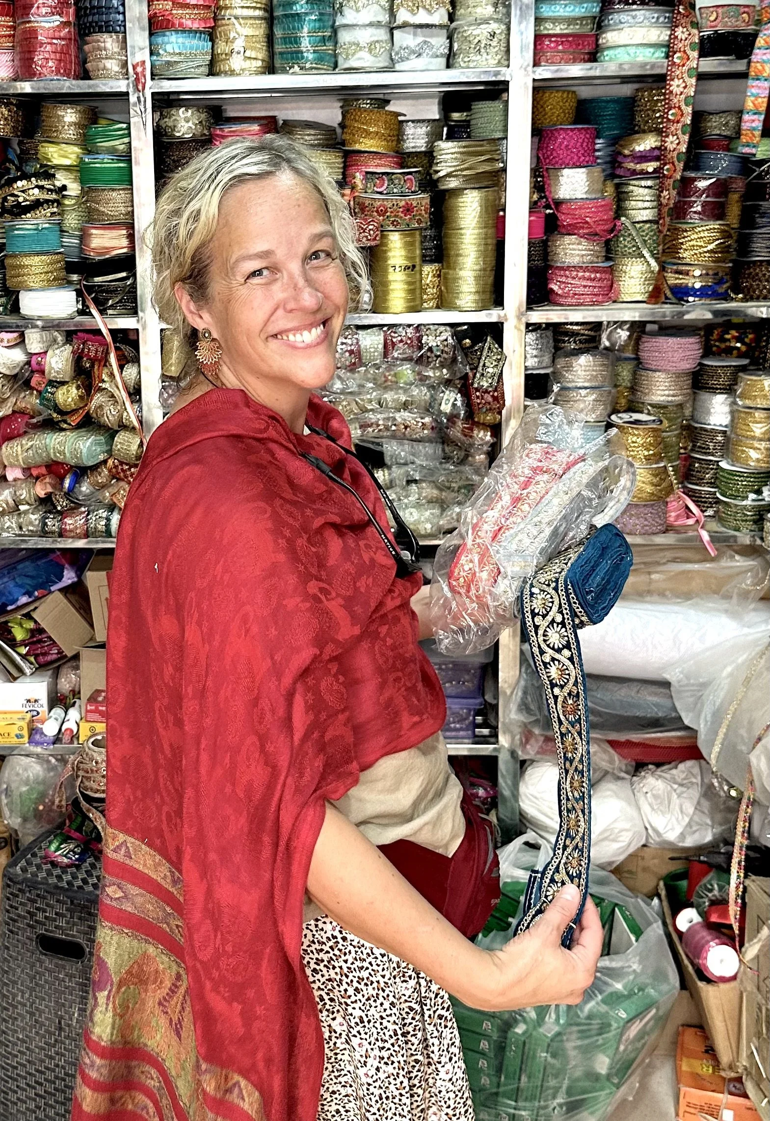 Cara Bothun, founder of Raspberry Tapestry, photographed among heirloom textiles and traditional patterns
