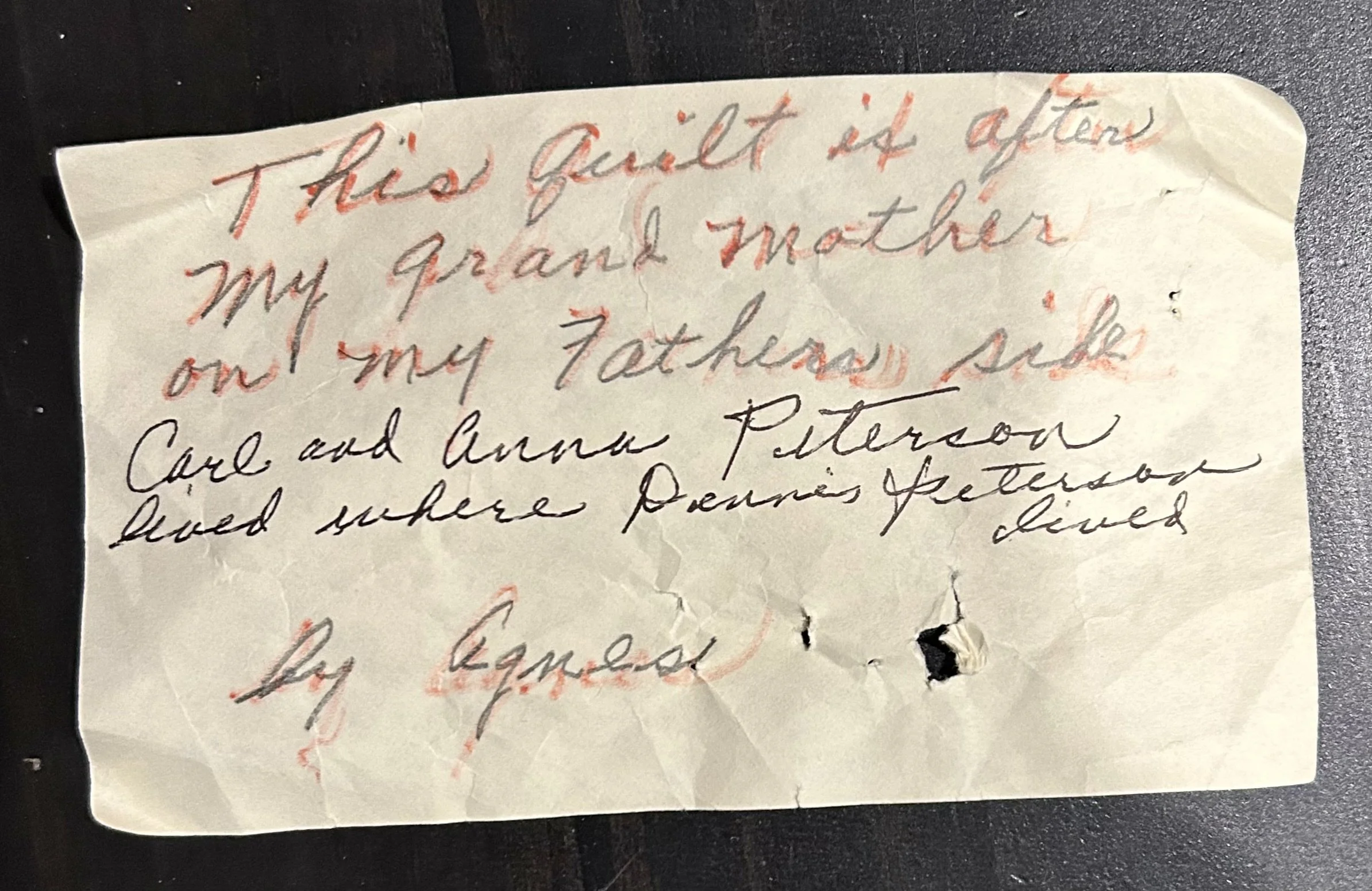 Handwritten family note identifying an heirloom quilt made by a great-grandmother and passed down through the family.