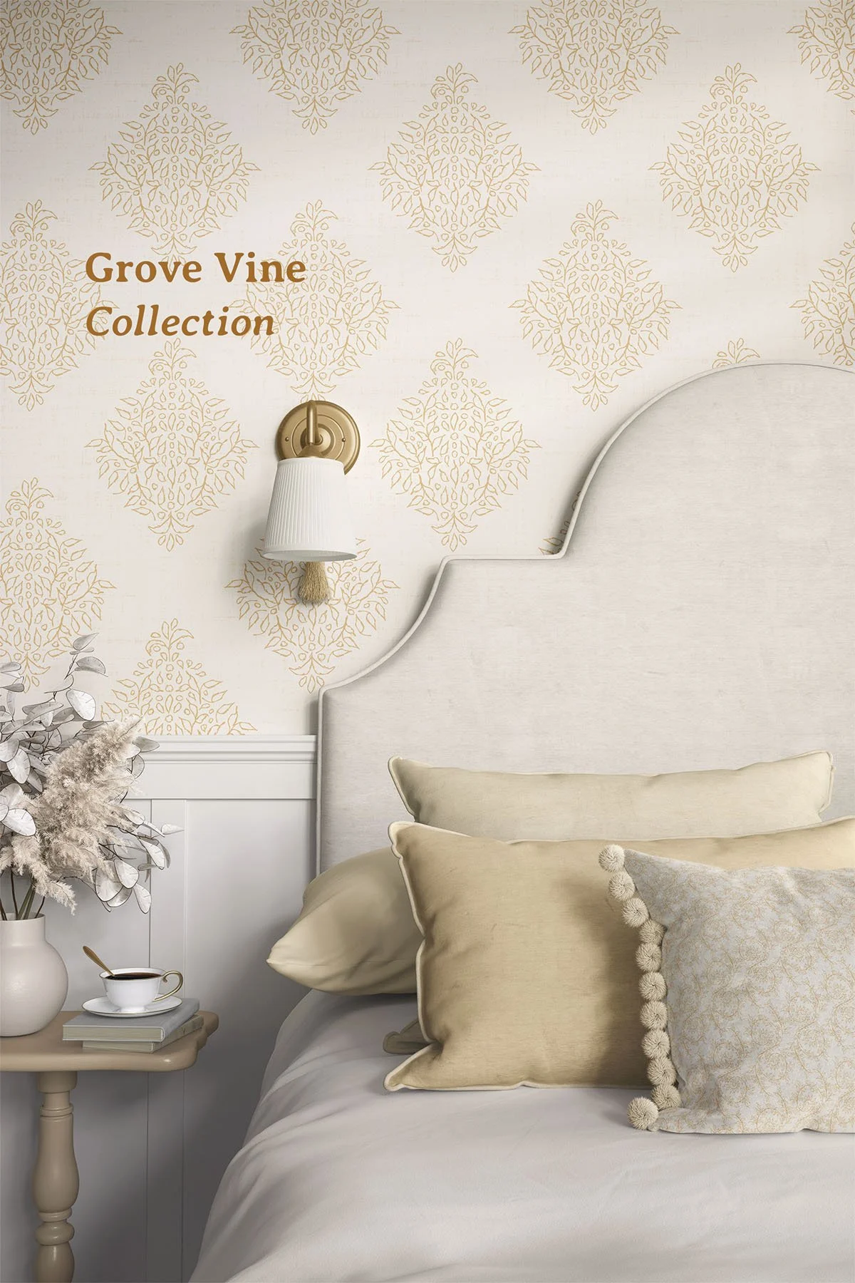 Elegant bedroom featuring Quiet Garden Damask wallpaper in Gold Antique Ivory with layered neutral bedding, a brass wall sconce, and the Grove Vine Collection by Raspberry Tapestry.