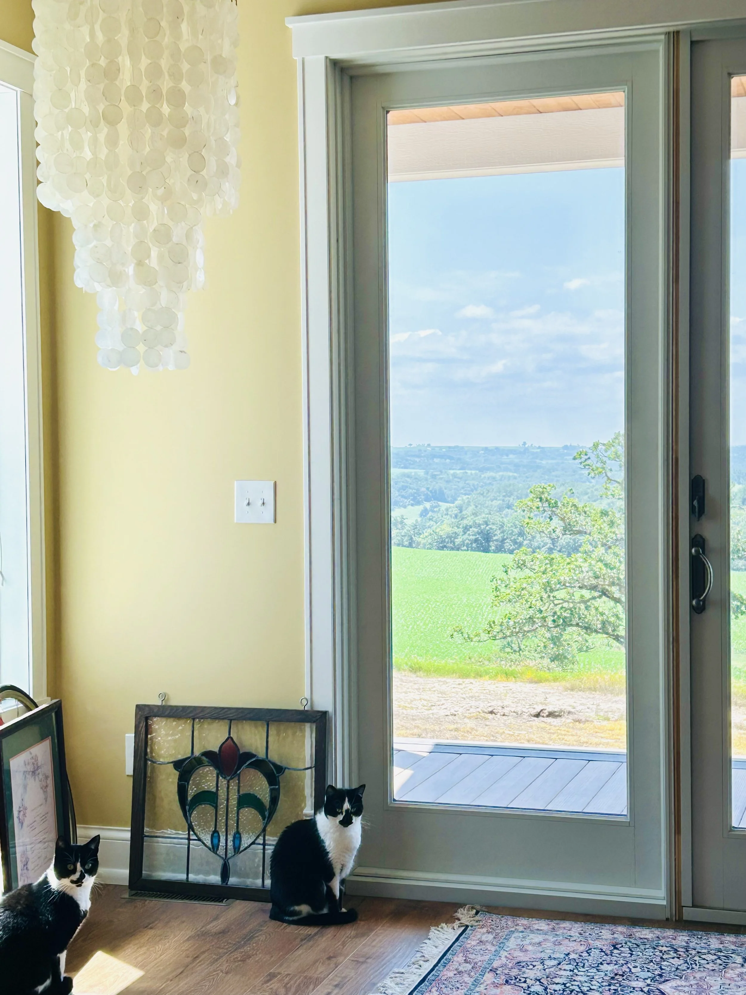 Capiz shell chandelier from Bali with stained-glass heart waiting to be hung beside windows overlooking the Minnesota countryside.
