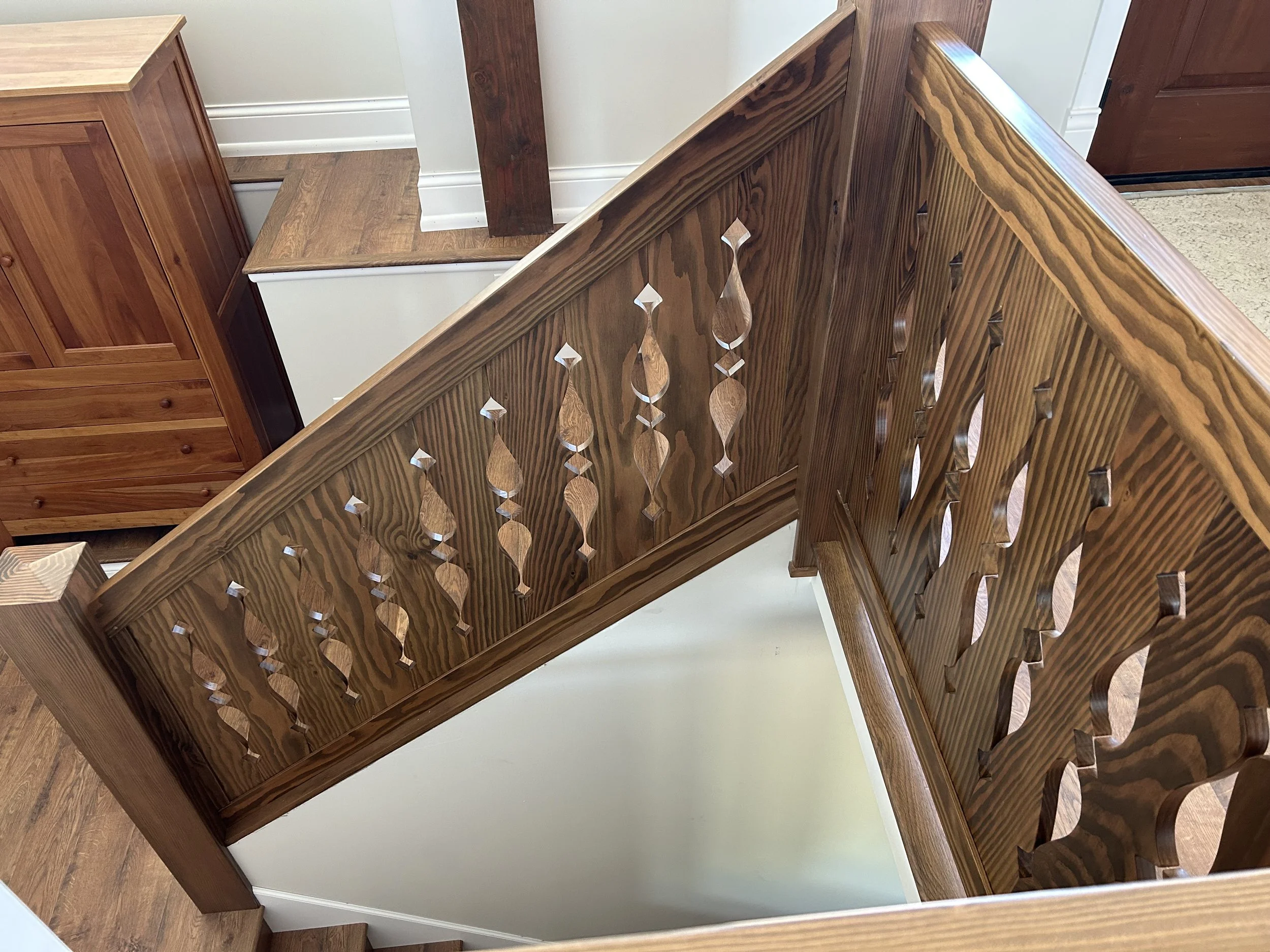 Custom wooden stair railing inspired by traditional Norwegian church carvings and heritage design motifs.
