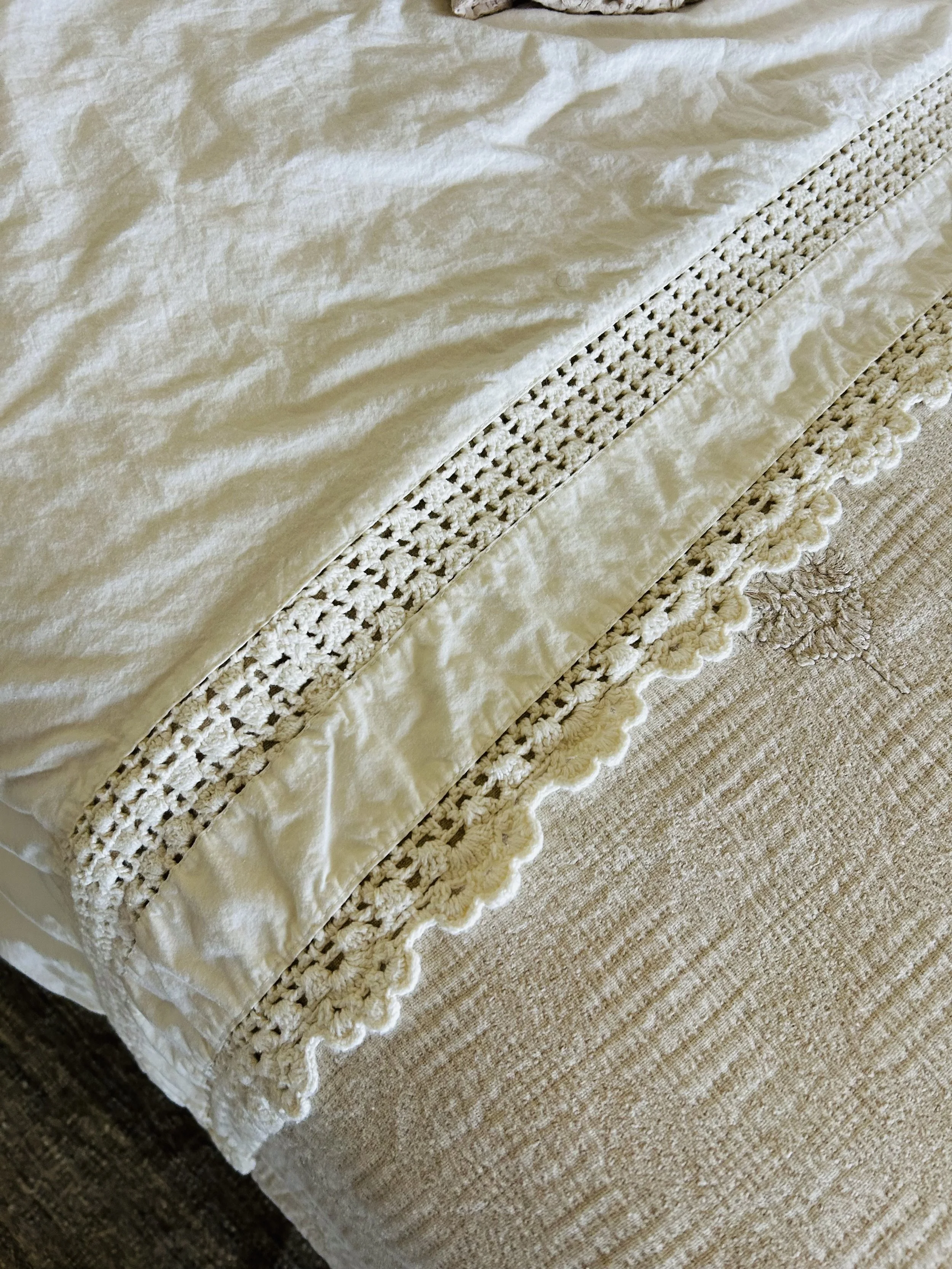 Handmade crocheted coverlet layered across the master bed, adding heirloom craftsmanship and timeless texture to our farmhouse bedroom.