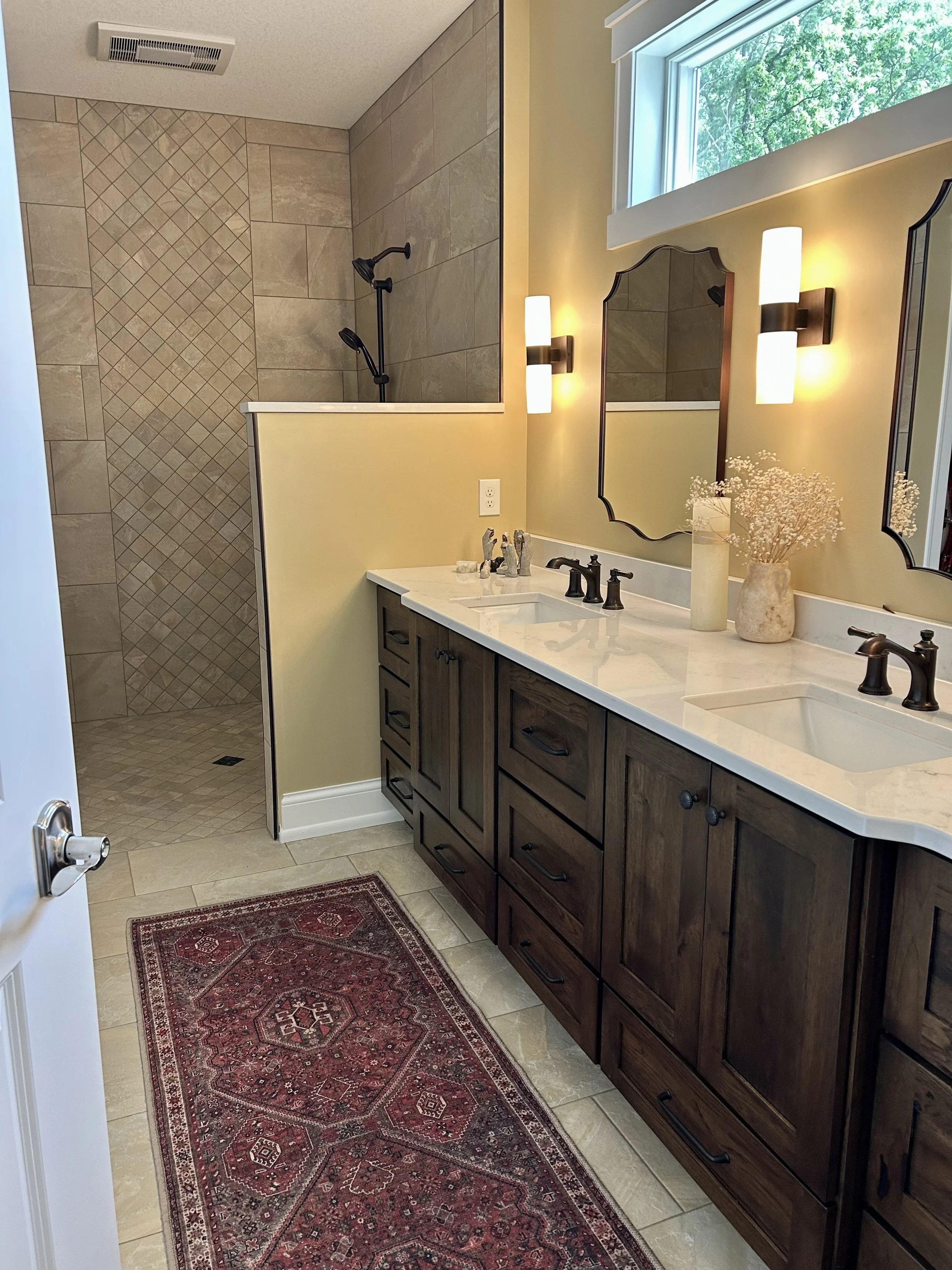 Warm Douglas fir vanity, quartz countertops, and walk-in tiled shower in the master bathroom.