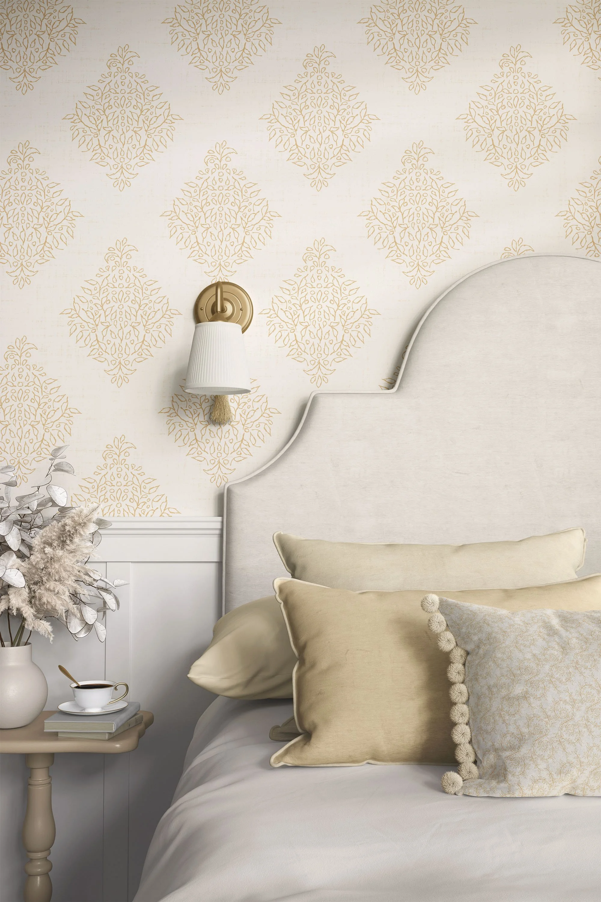 Classic bedroom with antique ivory damask wallpaper, layered neutral bedding, and traditional brass wall sconce.