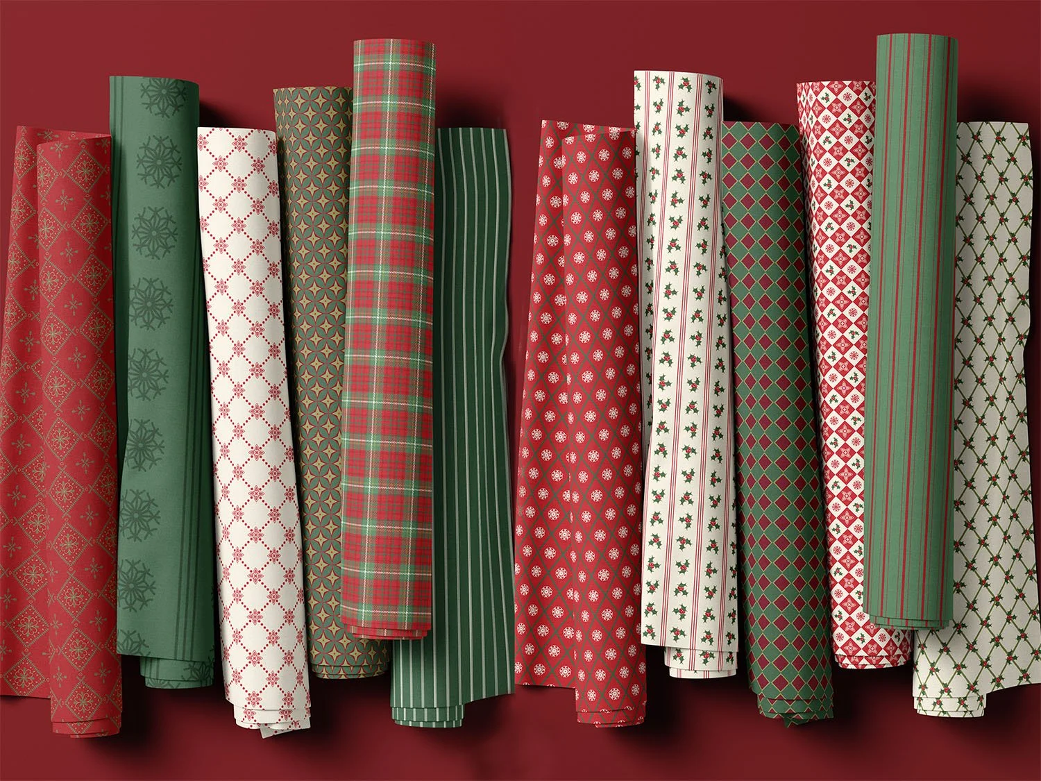 Coordinating red, green and ivory fabric rolls featuring stripes, plaid, holly and geometric patterns from the Traditional Bright Christmas Collection.