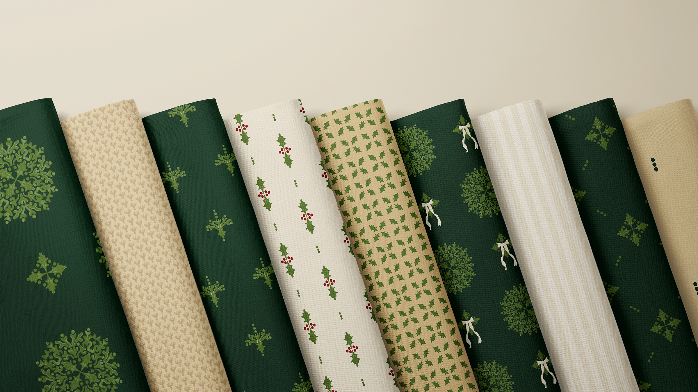 A curated stack of coordinating Heirloom Greenery Heritage Collection fabrics, showcasing the collection’s rich forest tones, classic motifs, and timeless seasonal palette.
