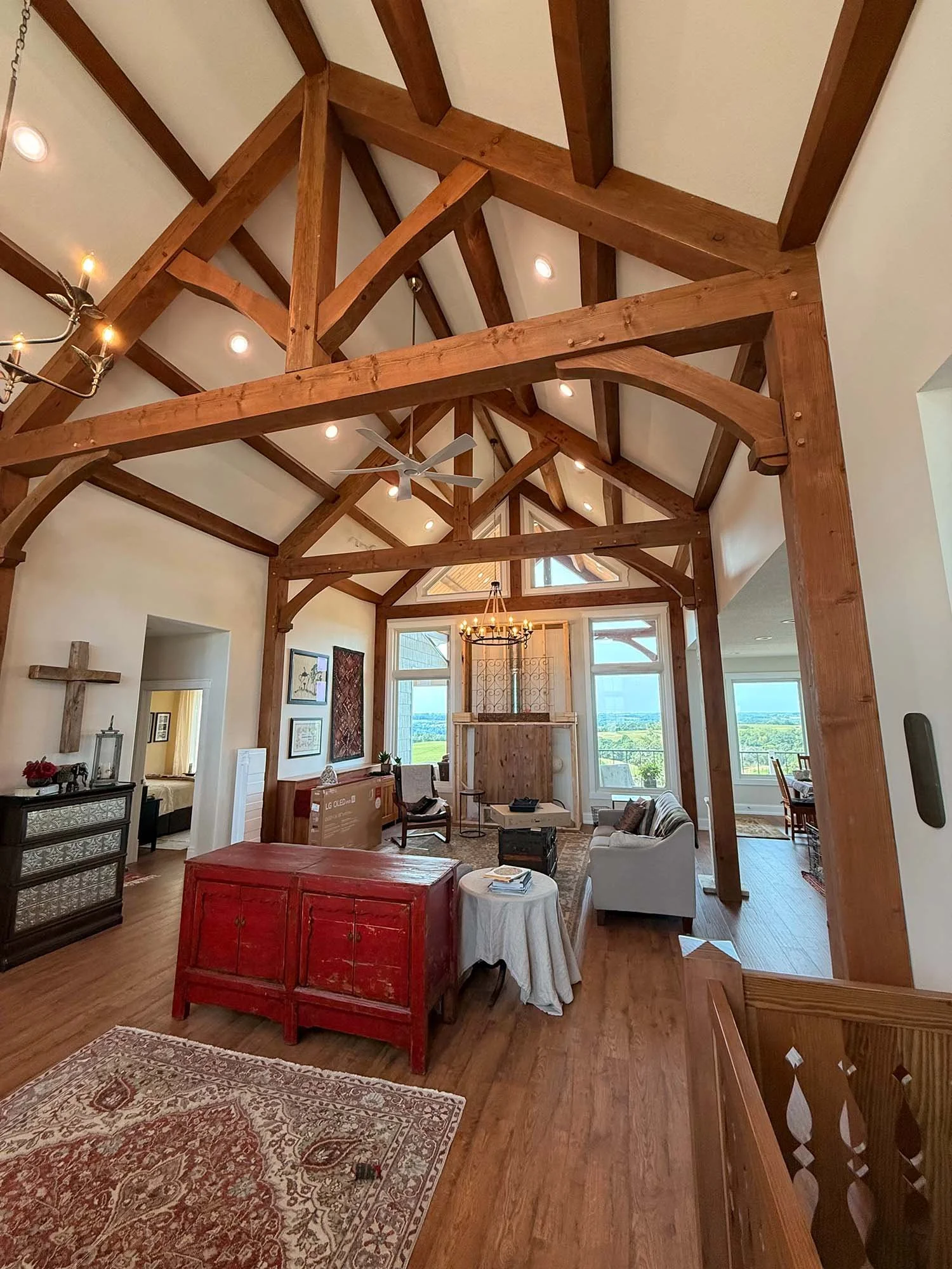 Finished great room with wood floors, exposed timber beams and furnishings, with Scripture written beneath the flooring during construction.