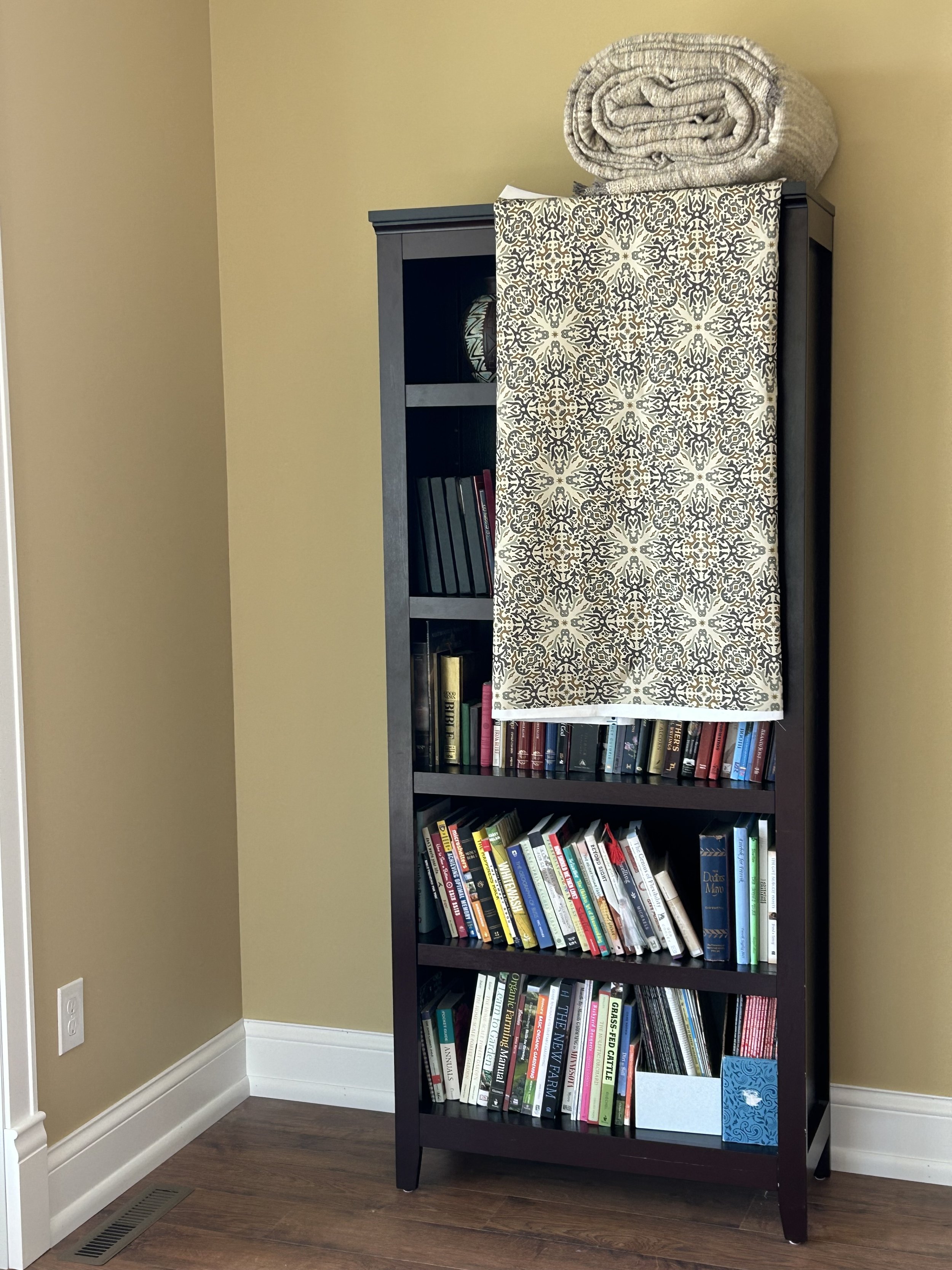 Surface pattern design fabric displayed as plans for a future fabric-covered accent wall in the master suite.