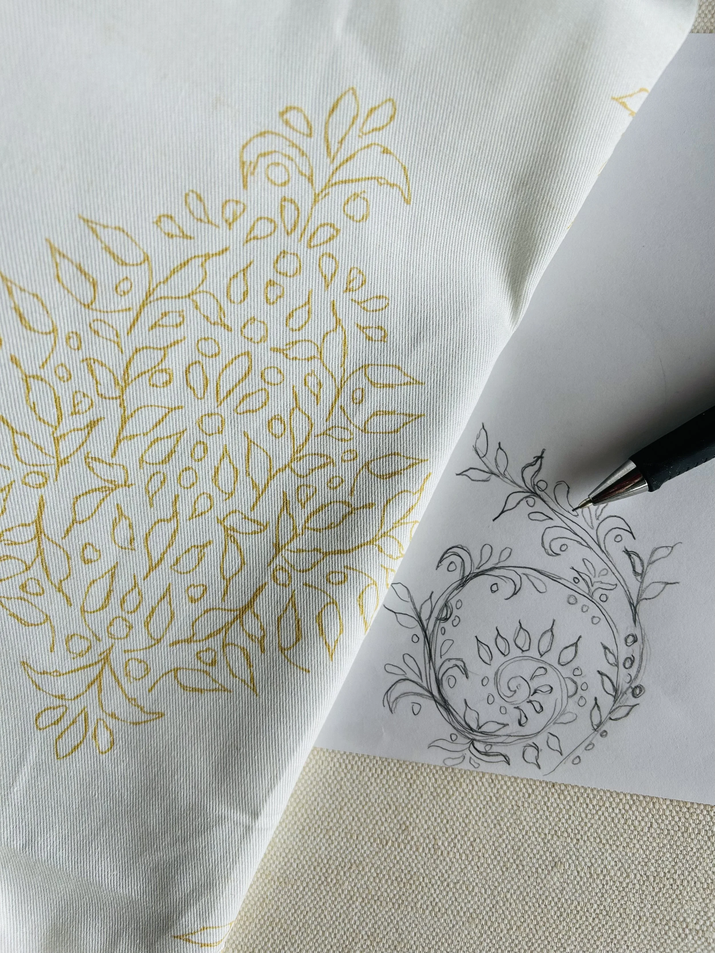 Hand-drawn Quiet Garden Damask botanical pencil sketch beside the finished Antique Gold and ivory pattern printed on fabric.