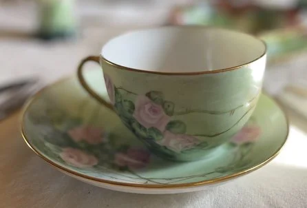 Handpainted teacup and saucer by Rosalie