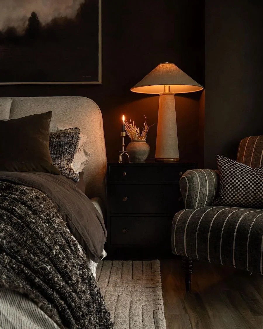 Dark, moody bedrooms are where elegance meets comfort. When done right, dark and moody equals sophistication &mdash; deep tones, rich textures, warm metals, and layered lighting come together to create a space that feels intimate, elevated, and invit