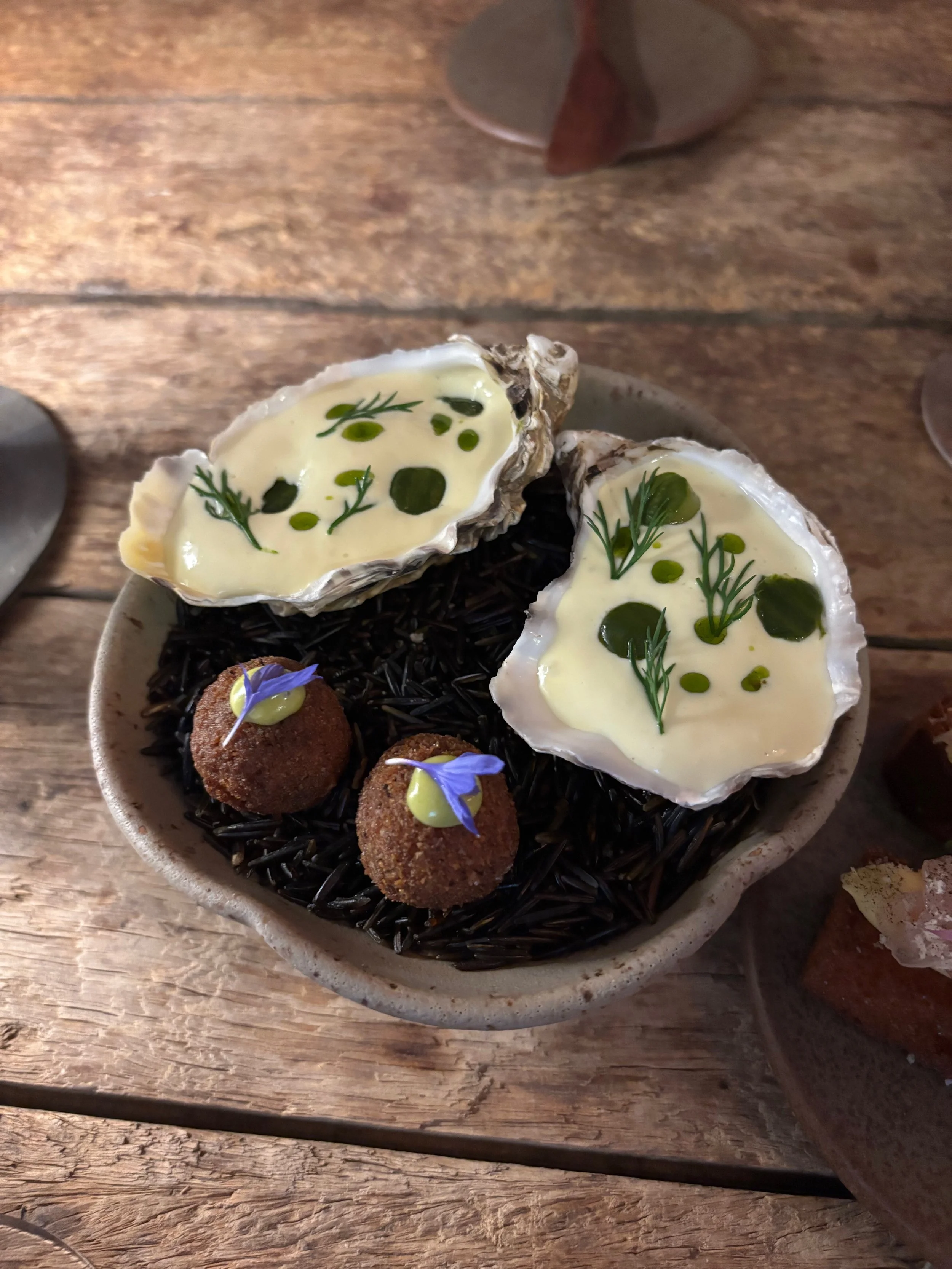 photo of two oysters and two fried cheese balls
