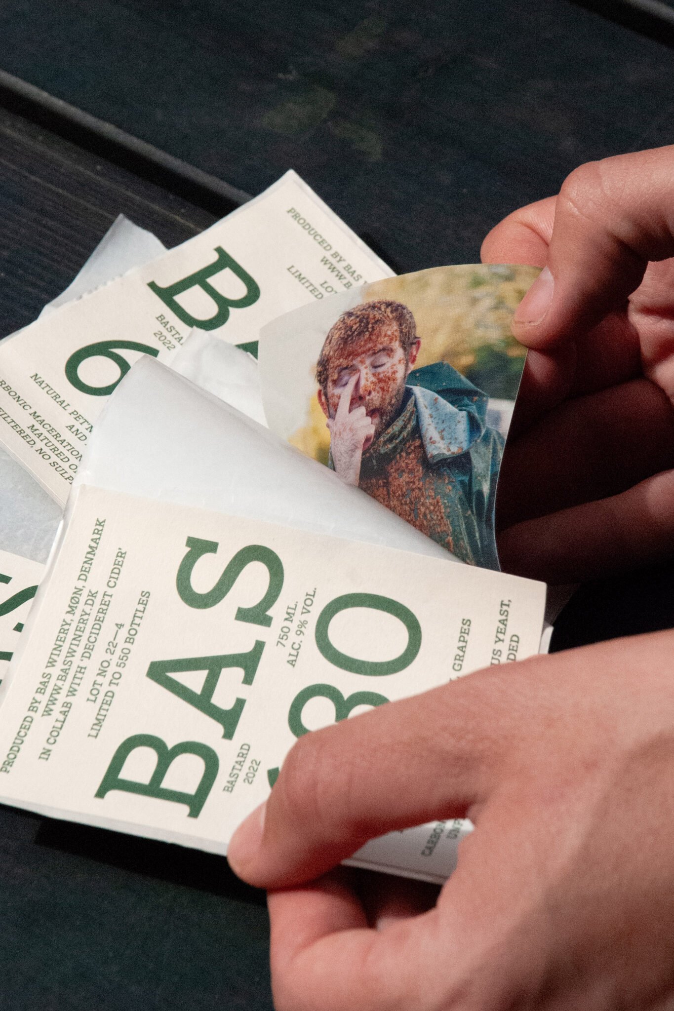 Person holding a wine label for Bas wine.