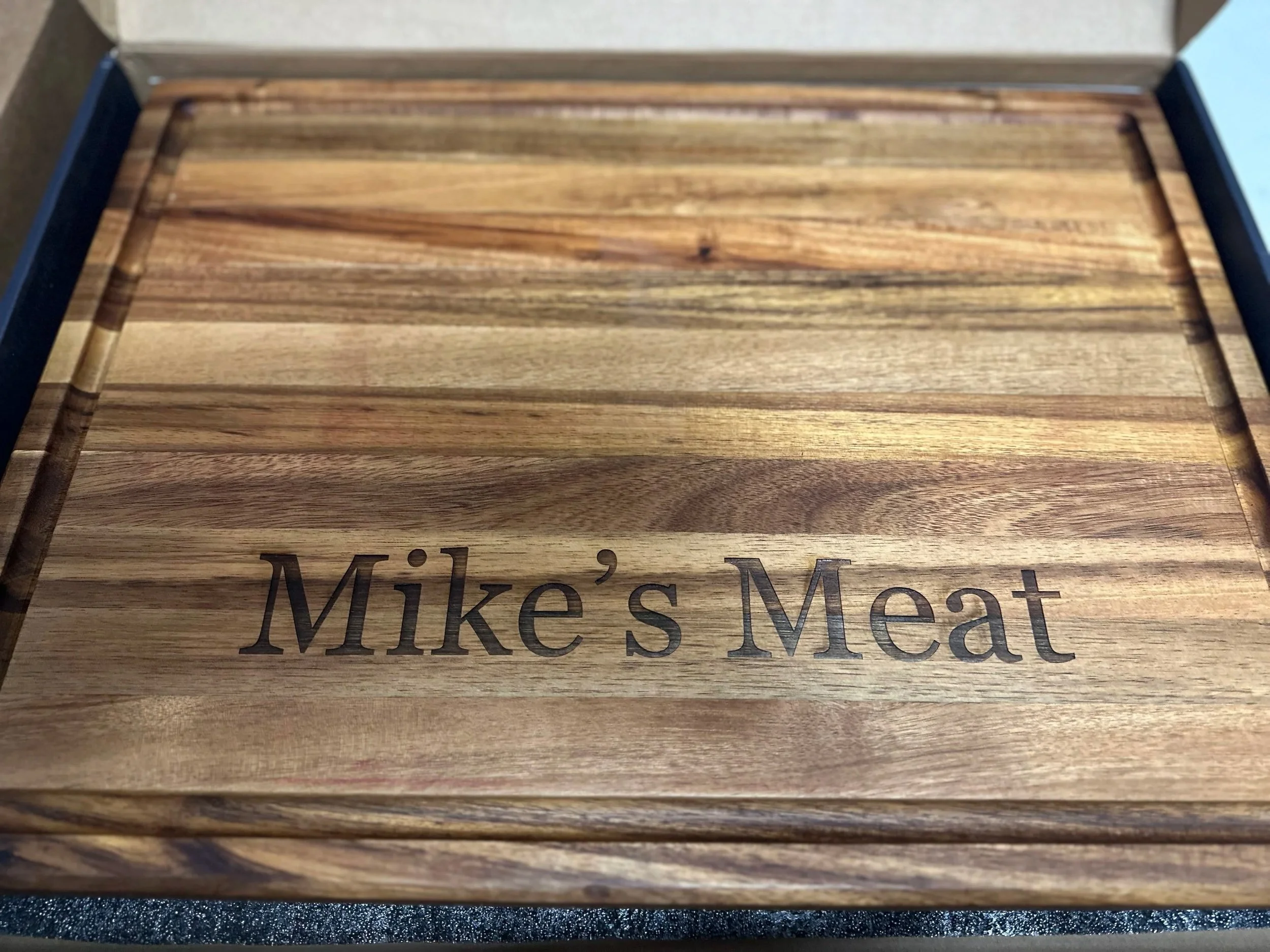 Wooden meat storage box labeled 'Mike's Meat' on the lid