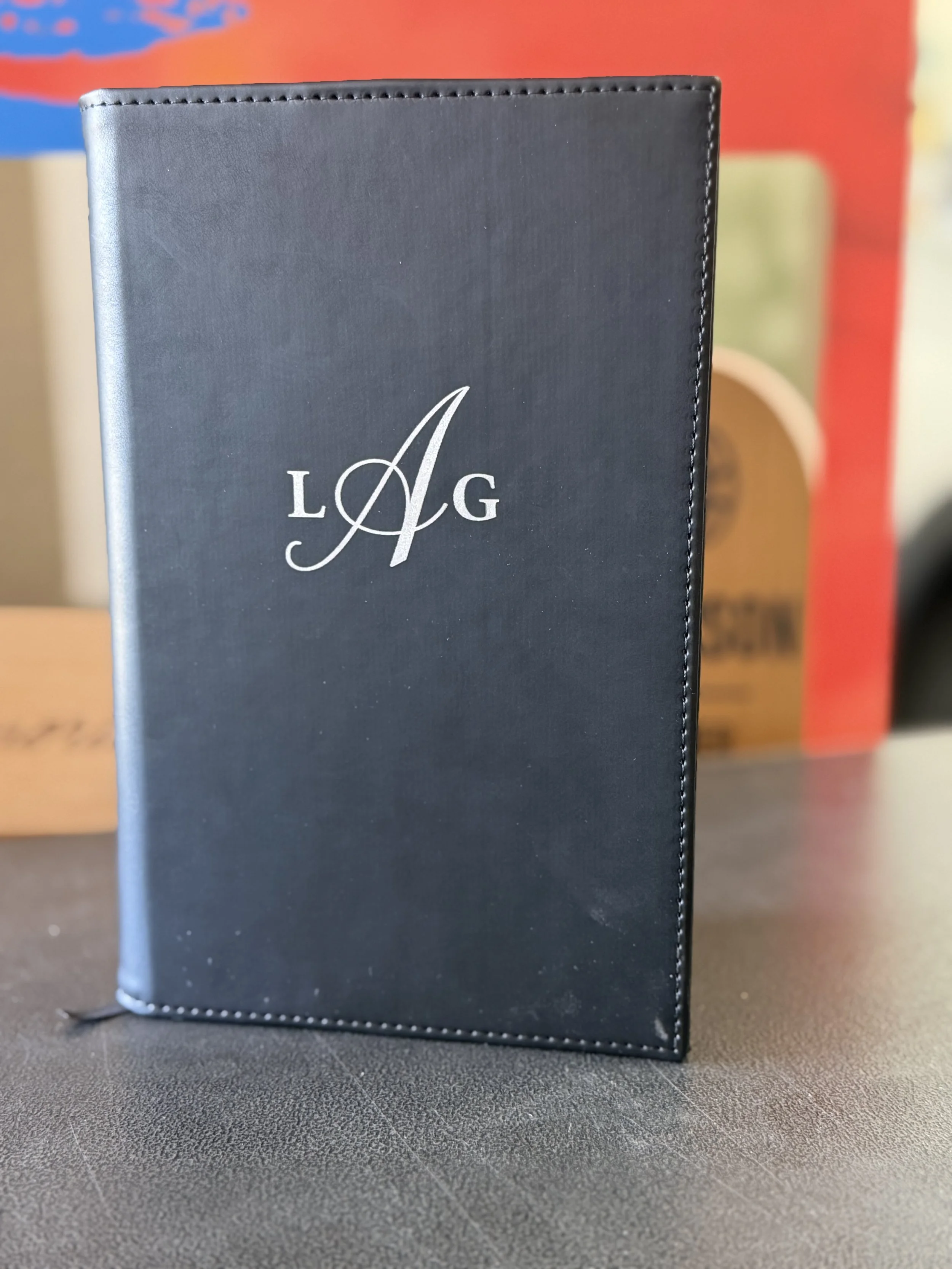 An engraved black leatherette journal