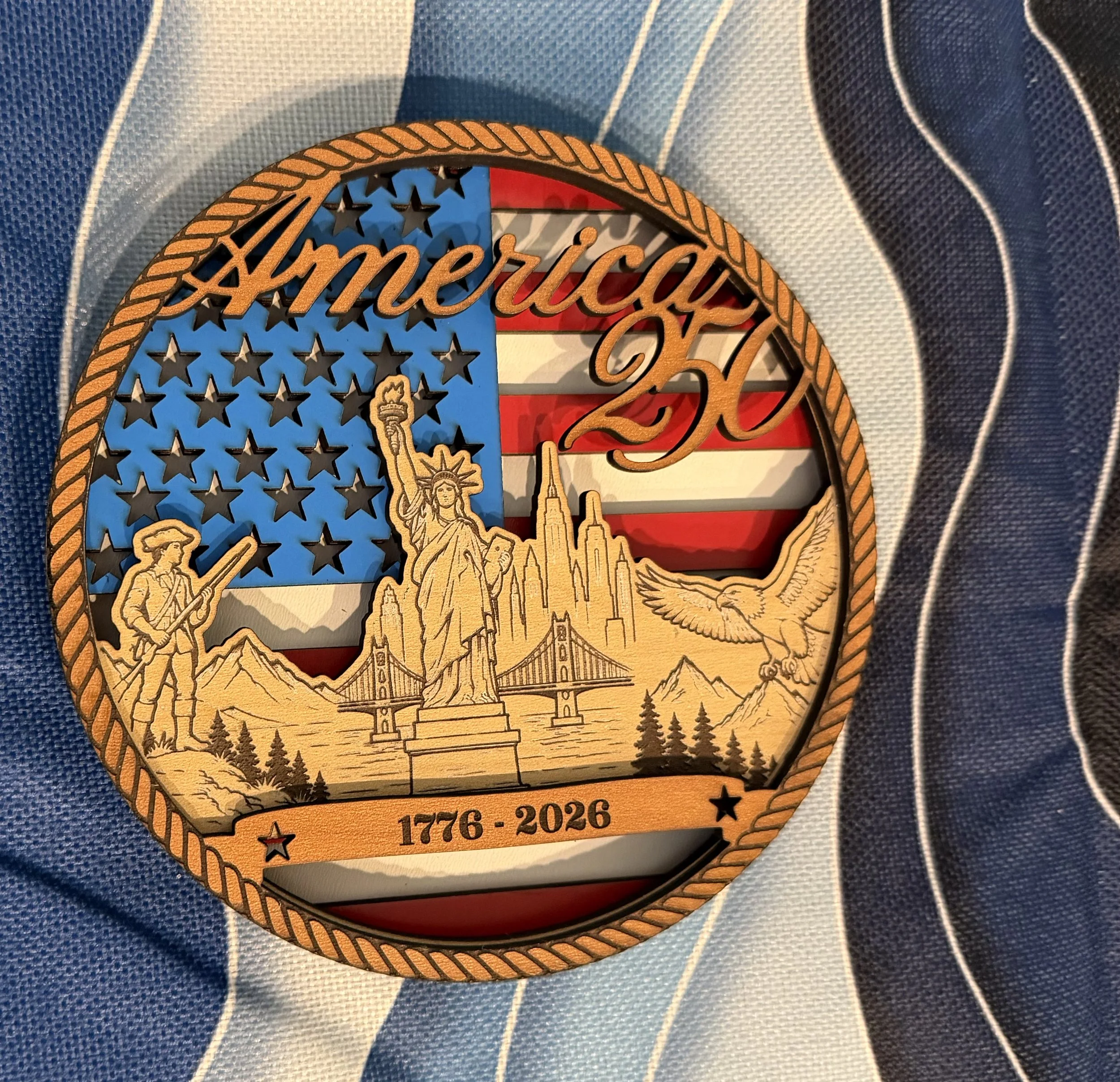 A unique 6" multilayered design featuring the Stars and Stripes, a patriot the Statue of Liberty, and the city skylines of New York and San Francisco
