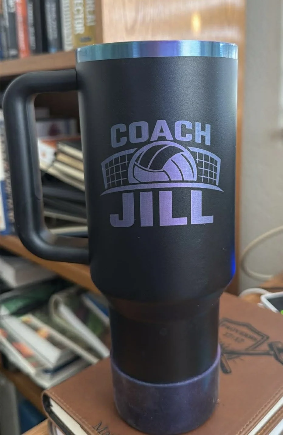 An engraved Stanley cup with a custom personalized logo