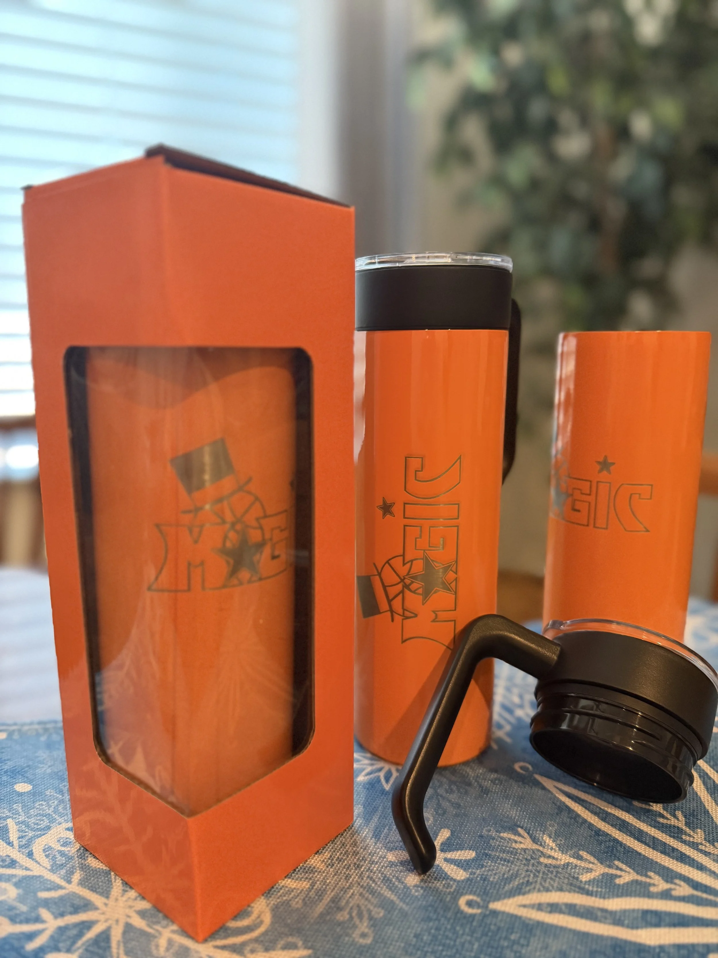 These tumblers were created for a local youth basketball team. The team colors are orange and blue. This is our 20 oz skinny tumbler, featuring an optional removable handle. It comes in 14 colors, and the handles are mix and match--so here we did a b