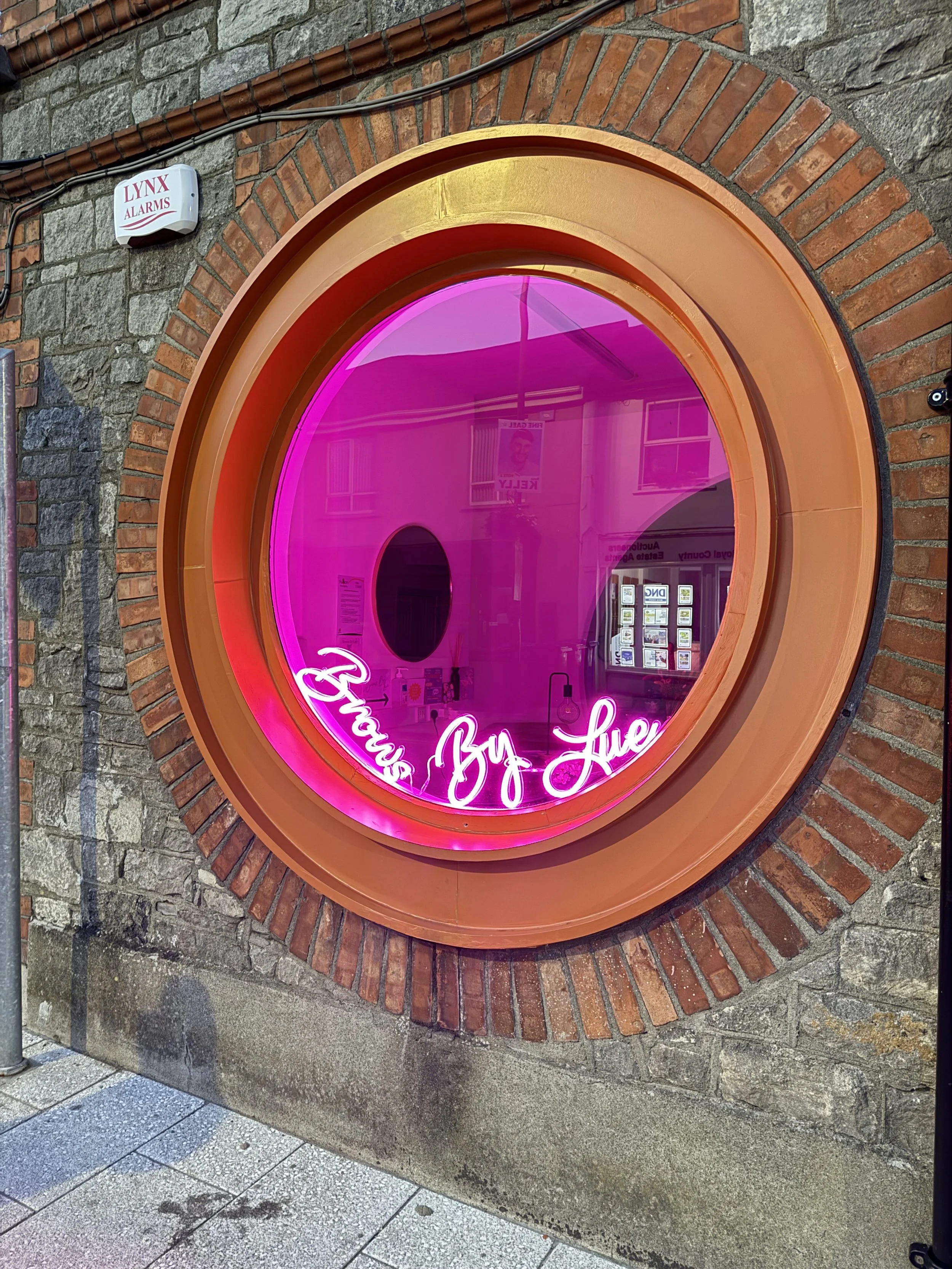 View through the window into Brows By Lue Meath salon, showcasing the inviting interior and stylish