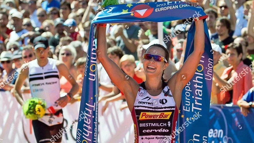 Rachel Joyce celebrating a triathlon victory