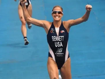 Laura Bennett running across the finish line