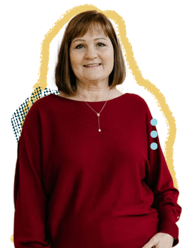 A woman with shoulder-length brown hair, wearing a red sweater and a necklace, smiling at the camera.