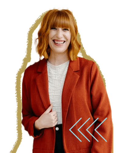 A woman with shoulder-length red hair, wearing a white shirt and an orange blazer, smiling and holding her blazer with her right hand.