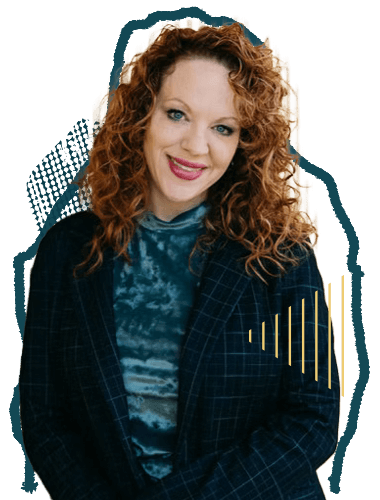 A woman with curly red hair smiling, wearing a shirt and a dark plaid blazer.