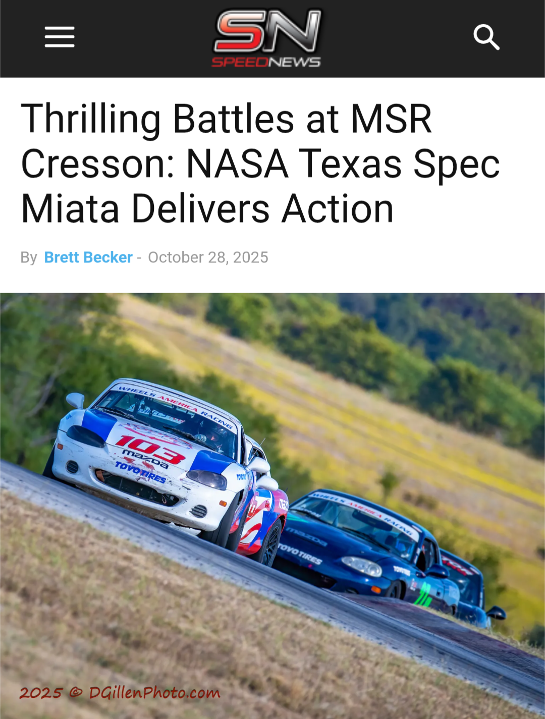 Two race cars on a track with a grassy, hilly background, one white with red and blue graphics and the other dark blue, competing in a motorsport event.