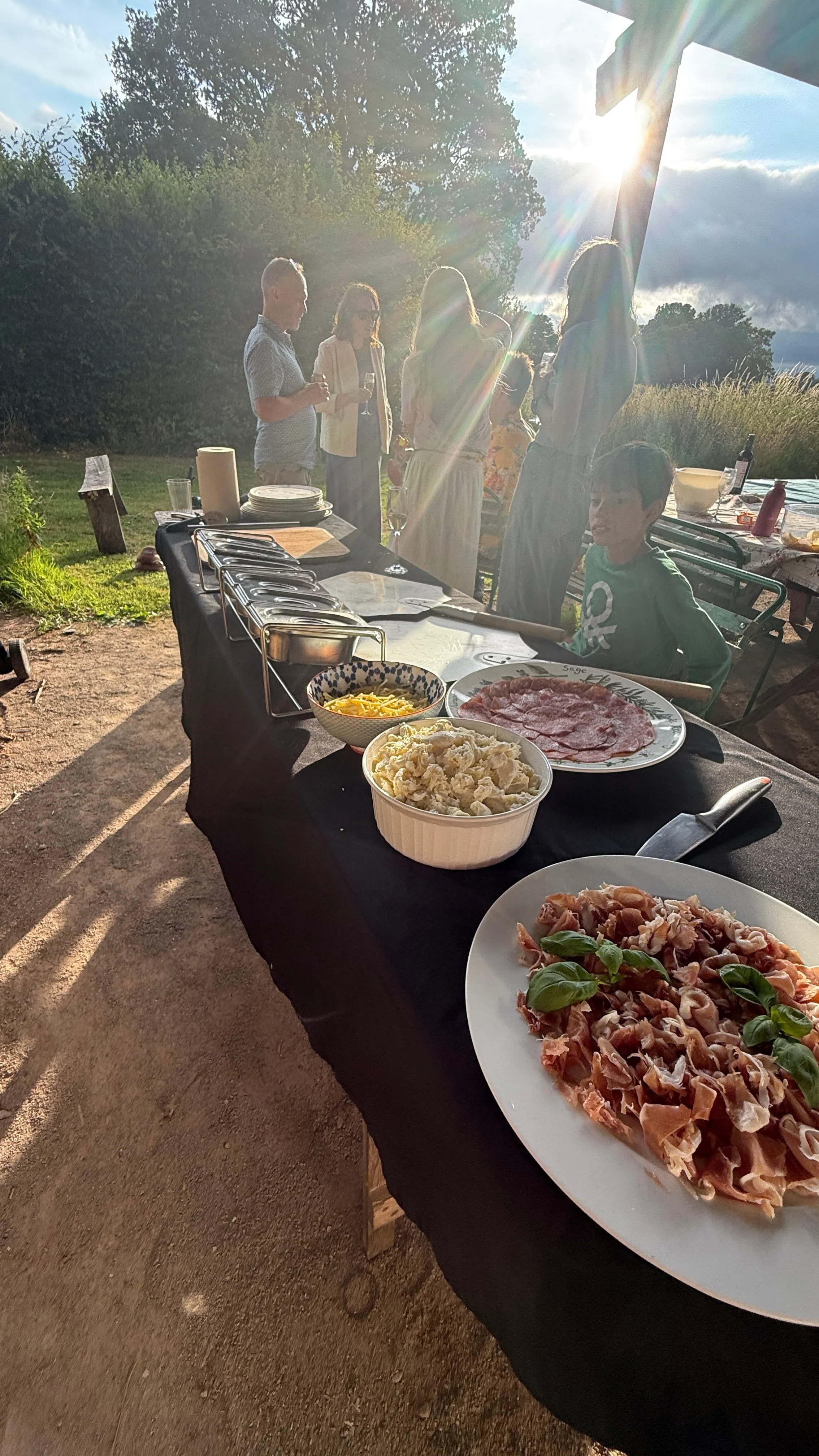 a family gathering around for food at box barn