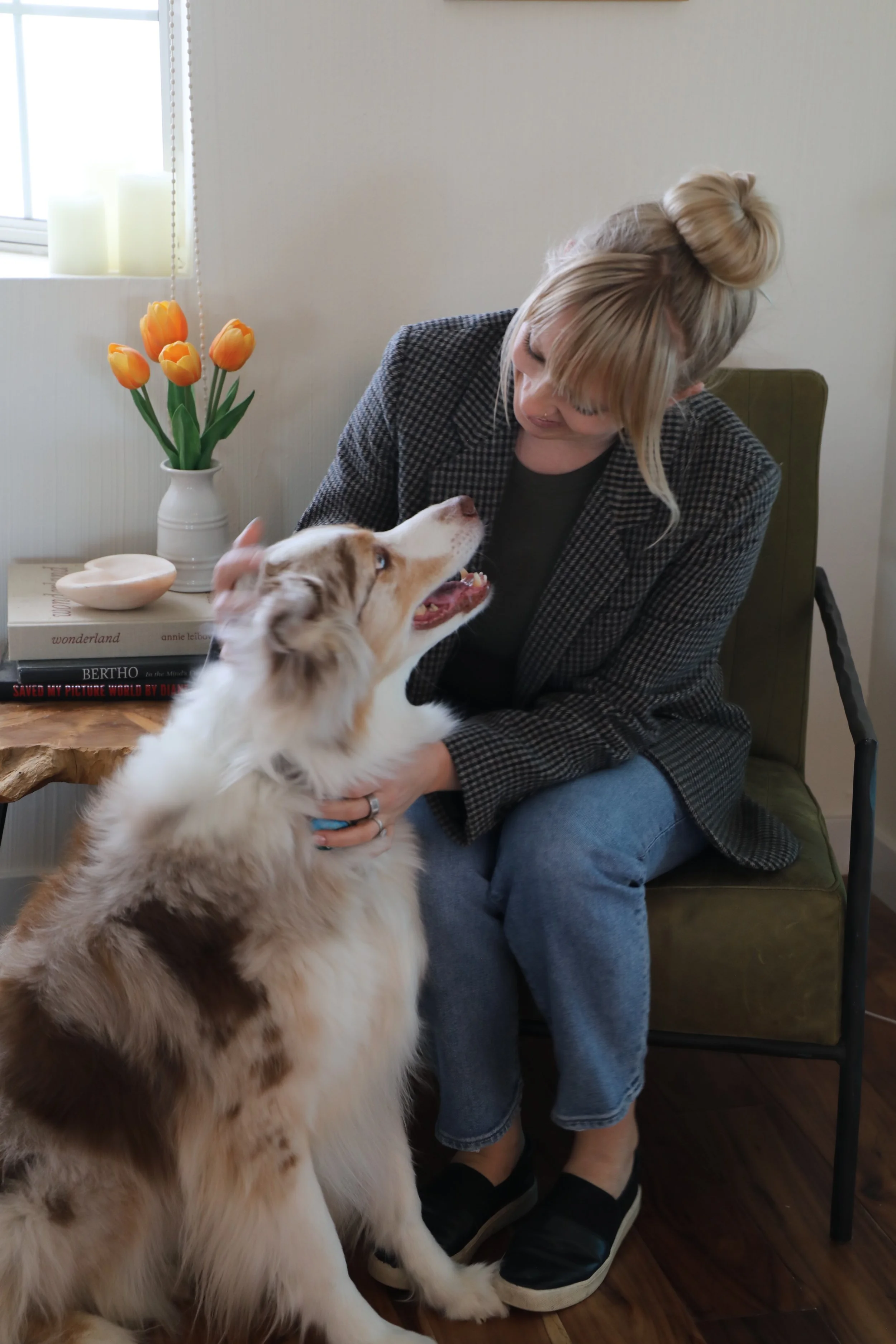 Family therapist Sophie Bain-Tohl sitting in a peaceful office with her dog, illustrating her trauma informed attachment based approach in Palm Desert, Ca