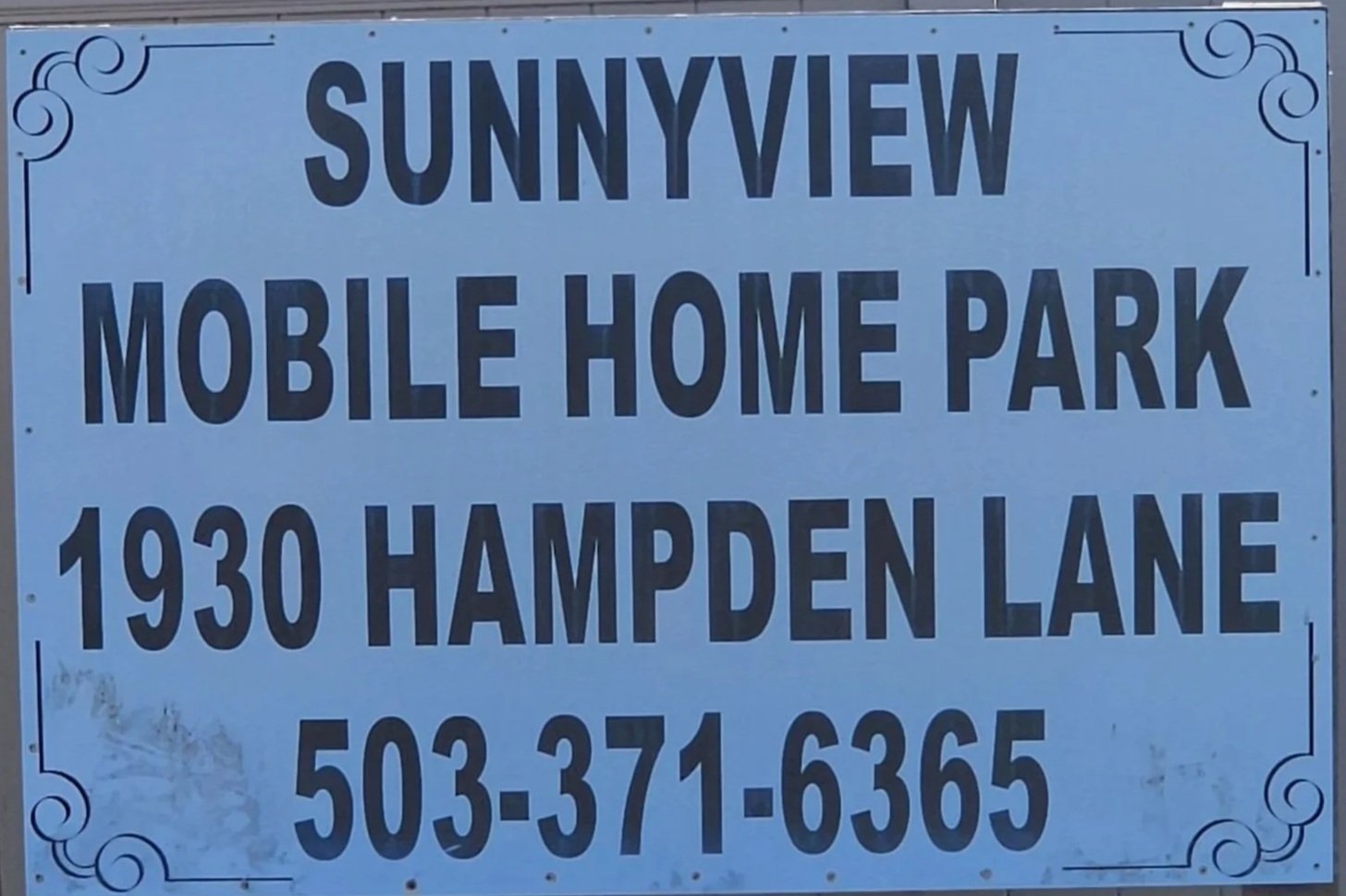 Sign for Sunnyview Mobile Home Park at 1930 Hampden Lane with phone number 503-371-6365, decorated with simple swirl border design.