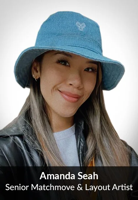 A young woman wearing a blue bucket hat, black leather jacket, and a light-colored shirt, smiling at the camera.