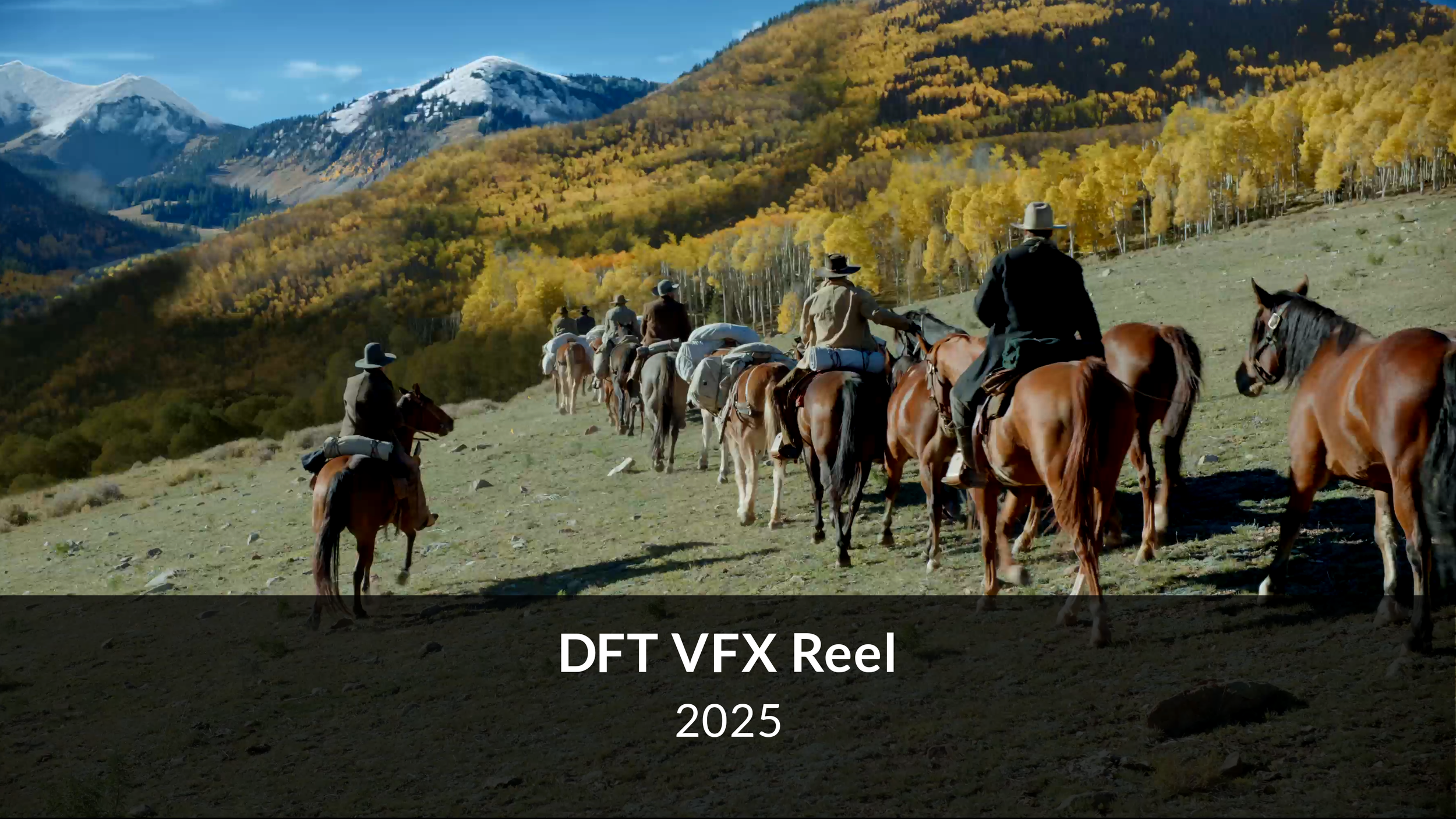 A group of people riding horses through a scenic mountain landscape with snow-capped peaks and colorful autumn trees.